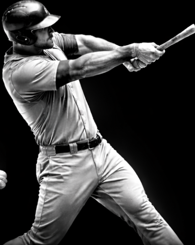 A male baseball player swinging a bat.