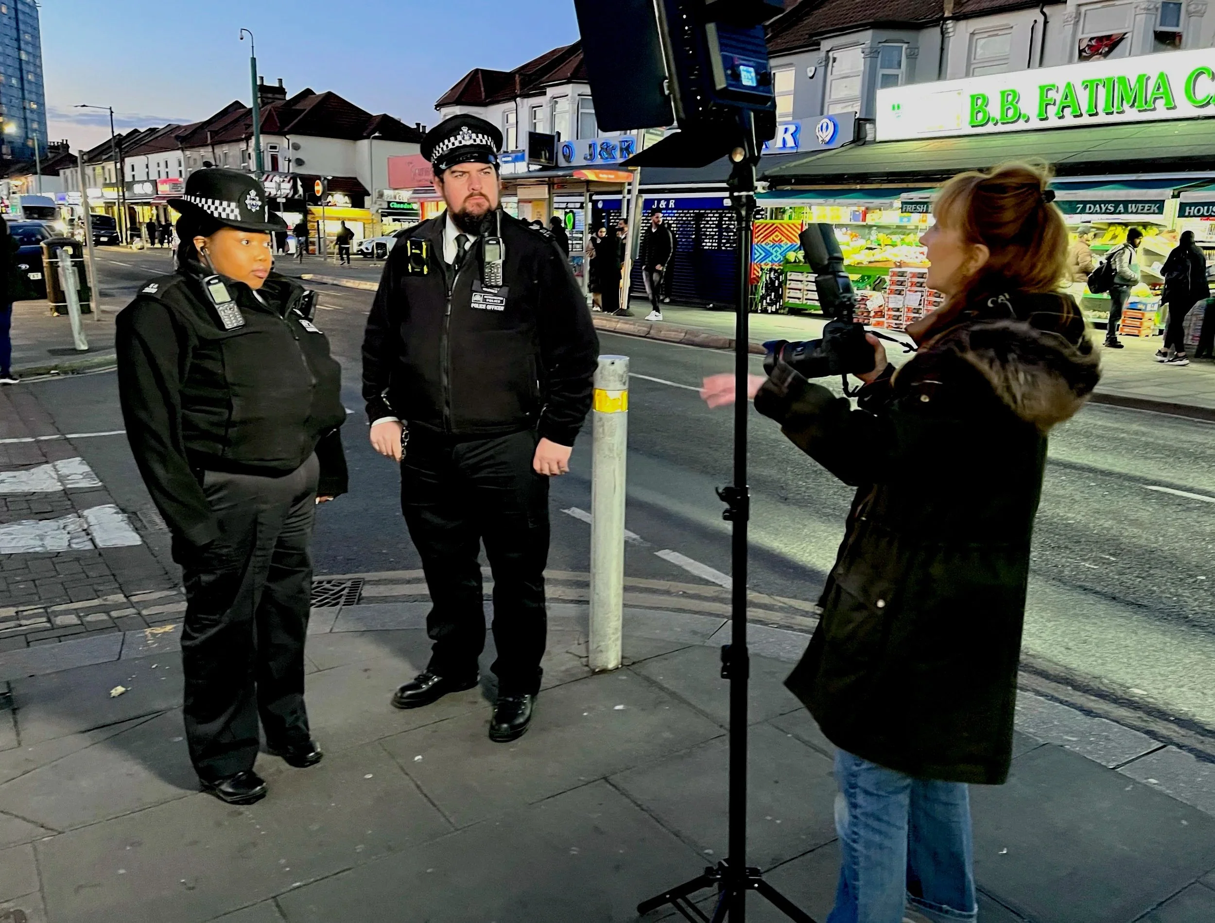 Behind the scenes image of Redbridge police being photographed on the street, for the poster campaign.