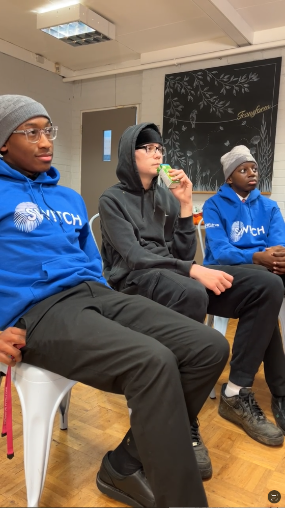 Three male students sat down listening to a Step In Workshop.