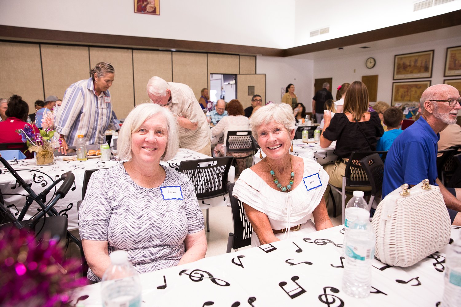 Two people smiling at a gathering