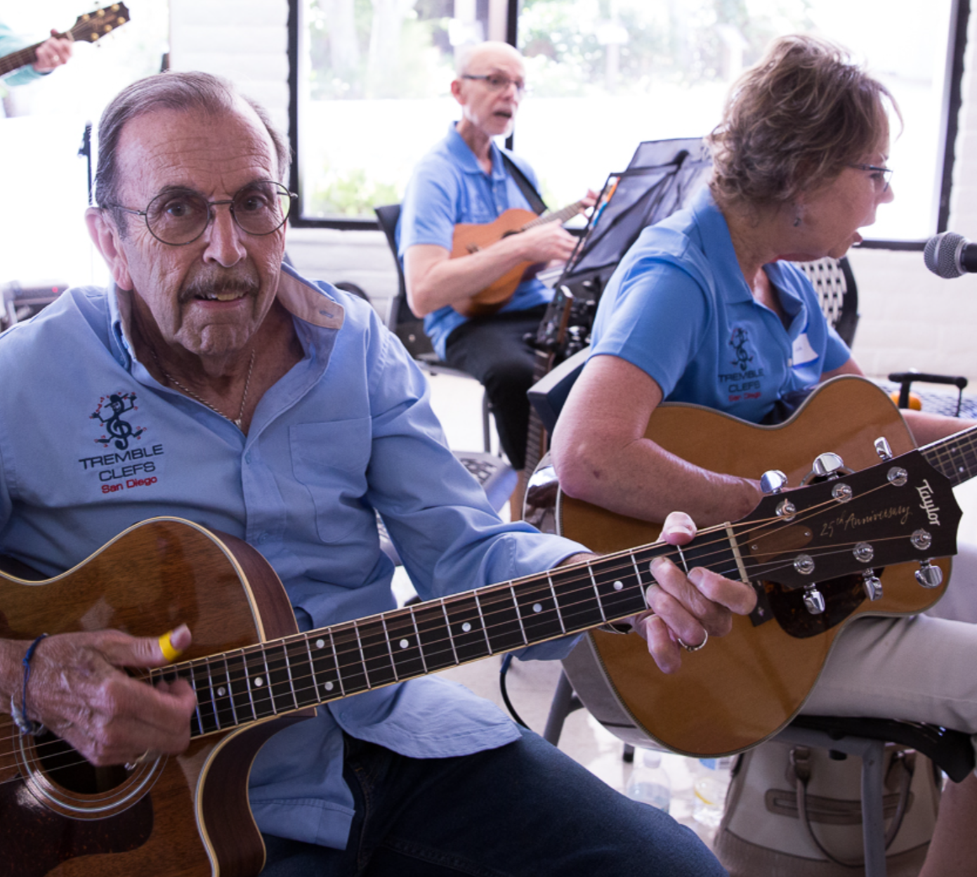 Photo of a volunteer member playing the guitar