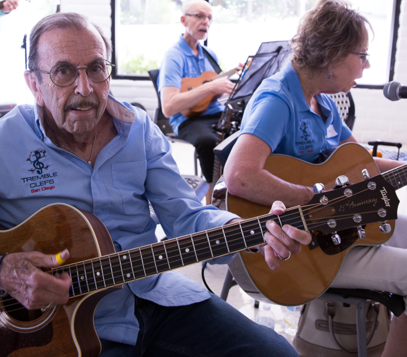 Photo of a volunteer member playing the guitar