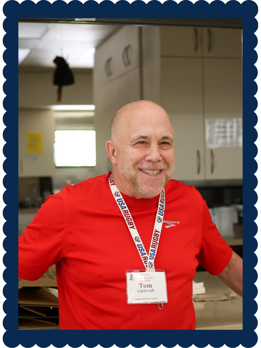 Framed photo on man in red shirt with a rugby sport lanyard