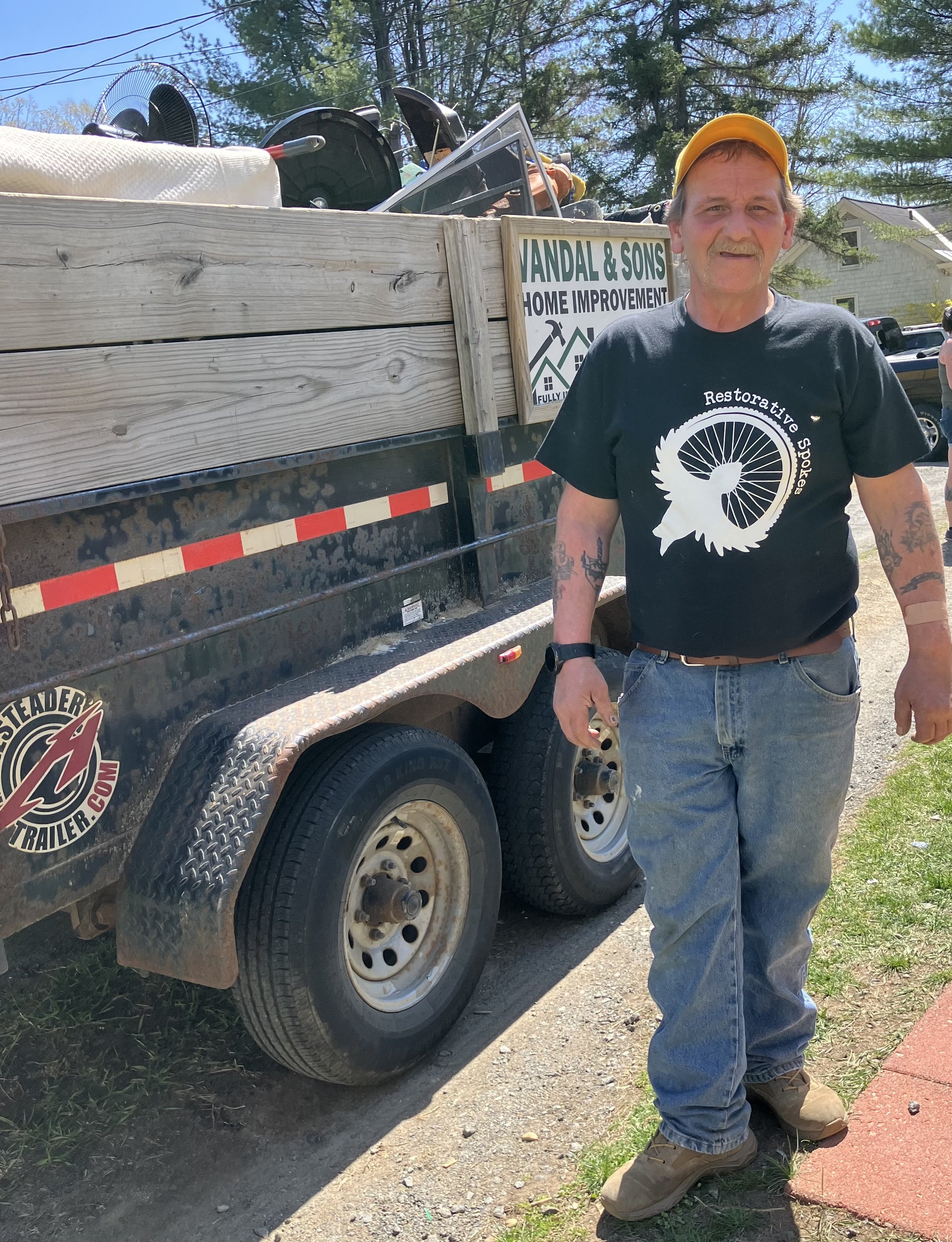 Ed Martin wearing a Restorative Spokes shirt and standing next to a truck