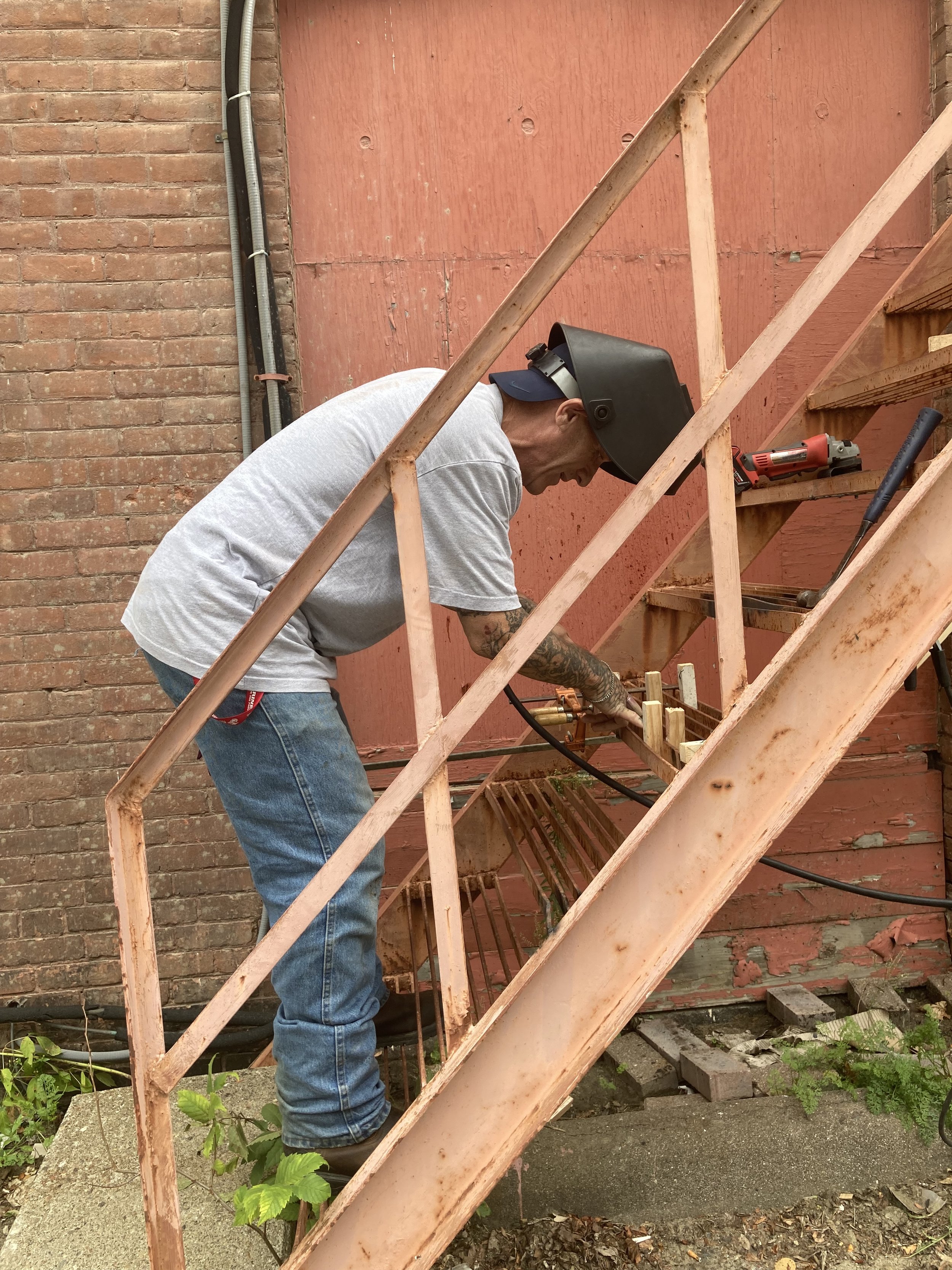 A volunteer working on a staircase