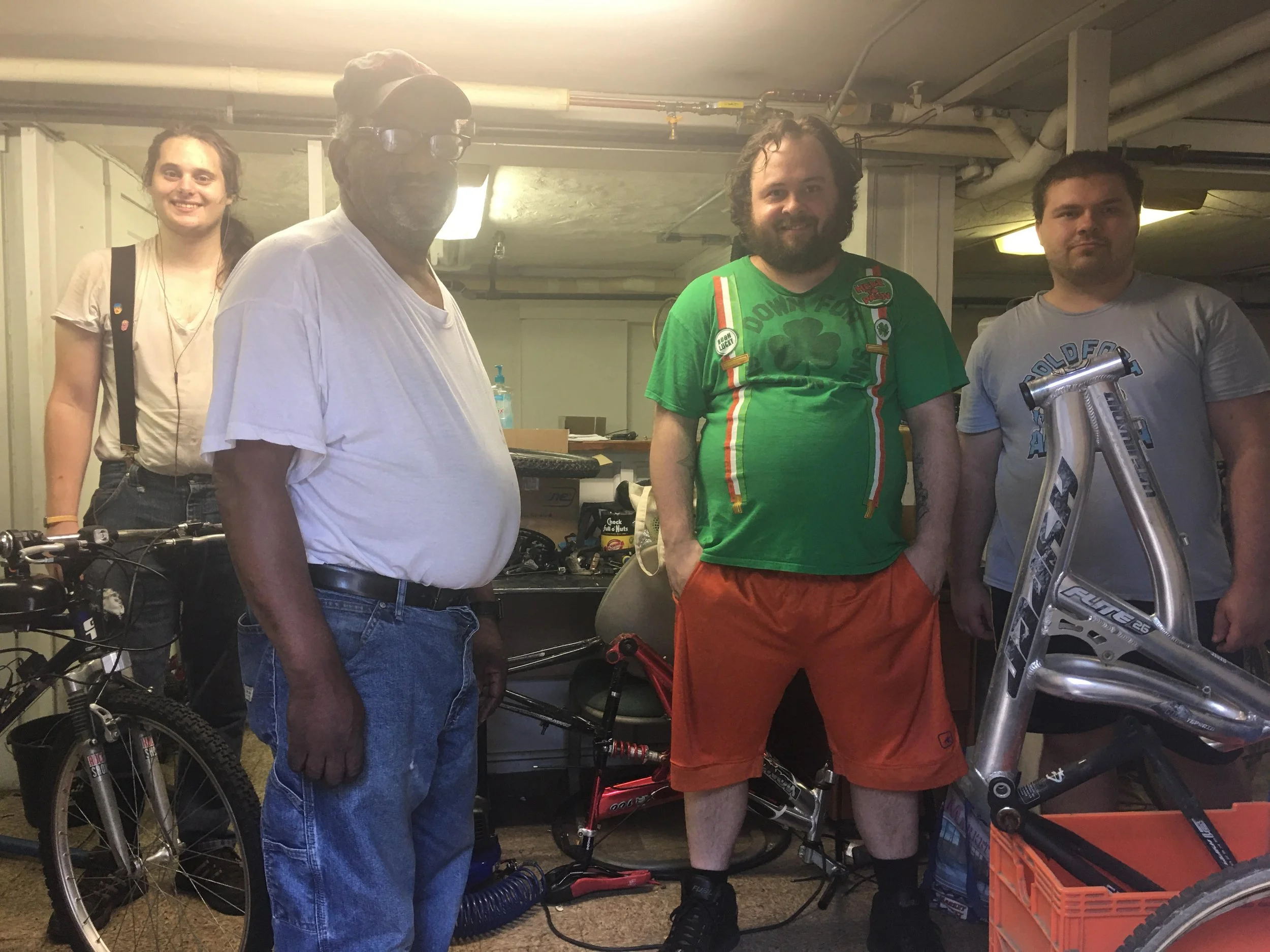 Thomas Miller (far left), bike mechanic, with volunteers