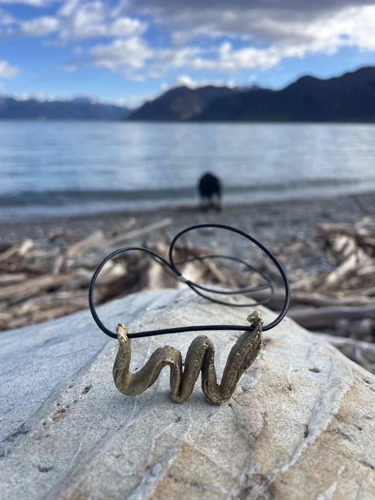 Organic textured bronze pendant created using the Japanese Mitsuro Hikime technique, with leather cord and sterling silver stopper.