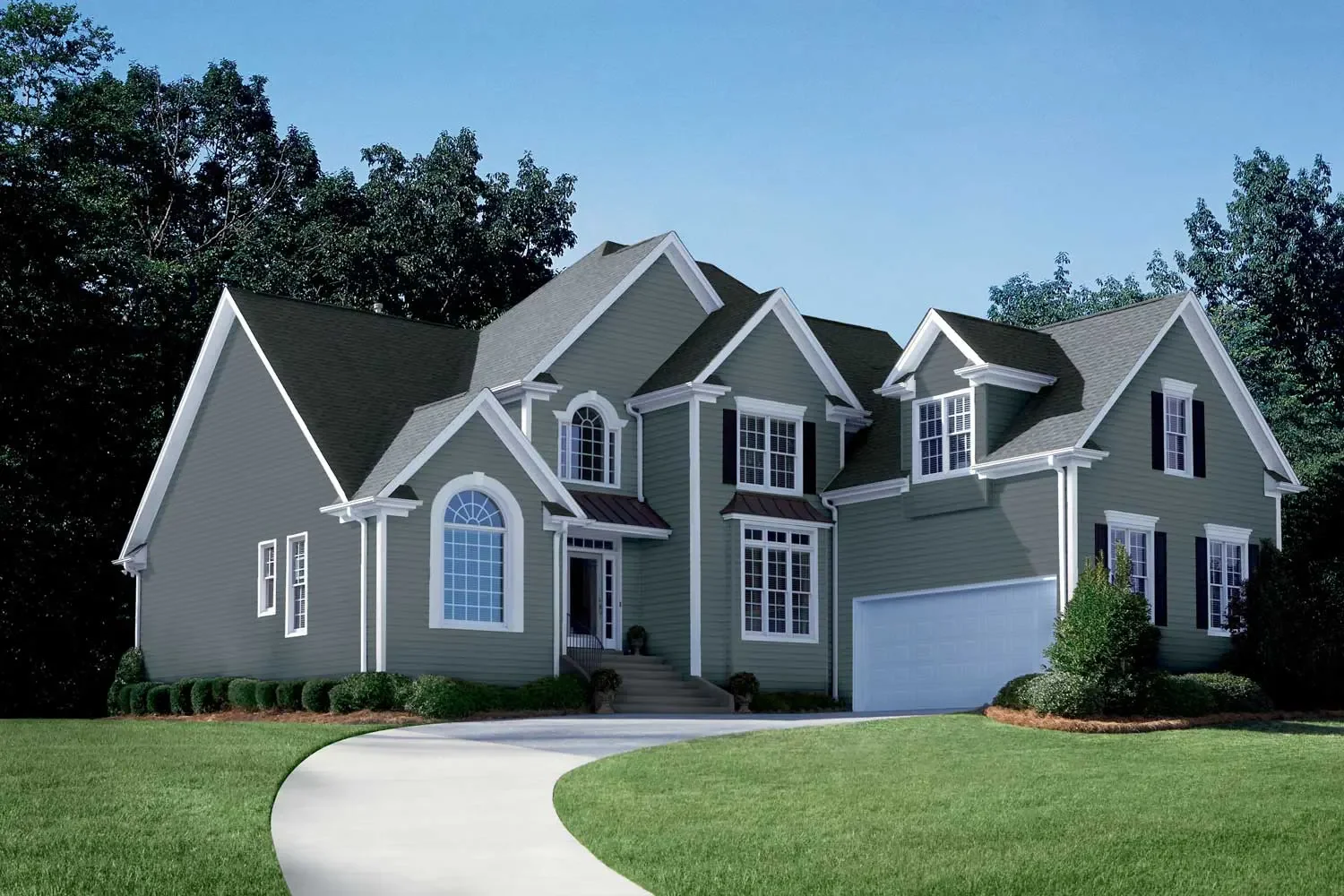 Front view of a large, two-story suburban house with gray siding and white trim, a curved driveway, and a well-maintained lawn with shrubs and trees in the background.