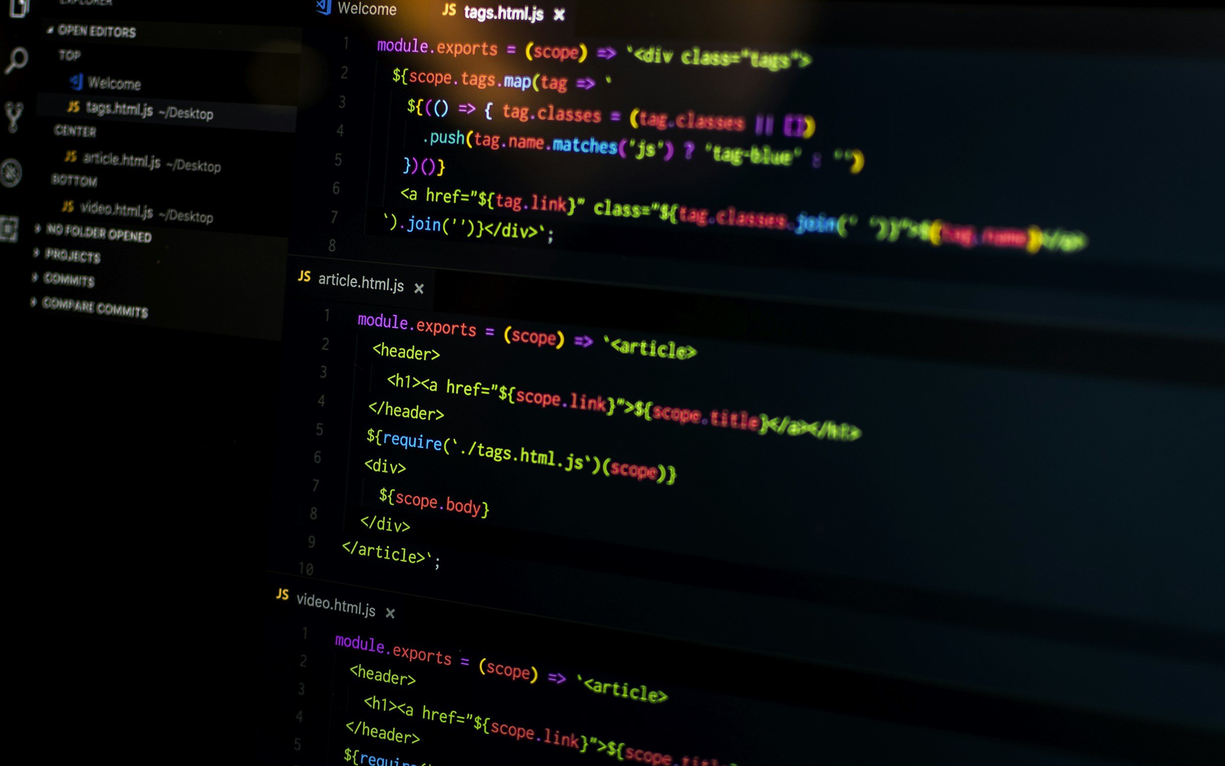 Computer screen displaying code snippets in JavaScript, HTML, and CSS with syntax highlighting in colors such as purple, yellow, green, red, and blue.