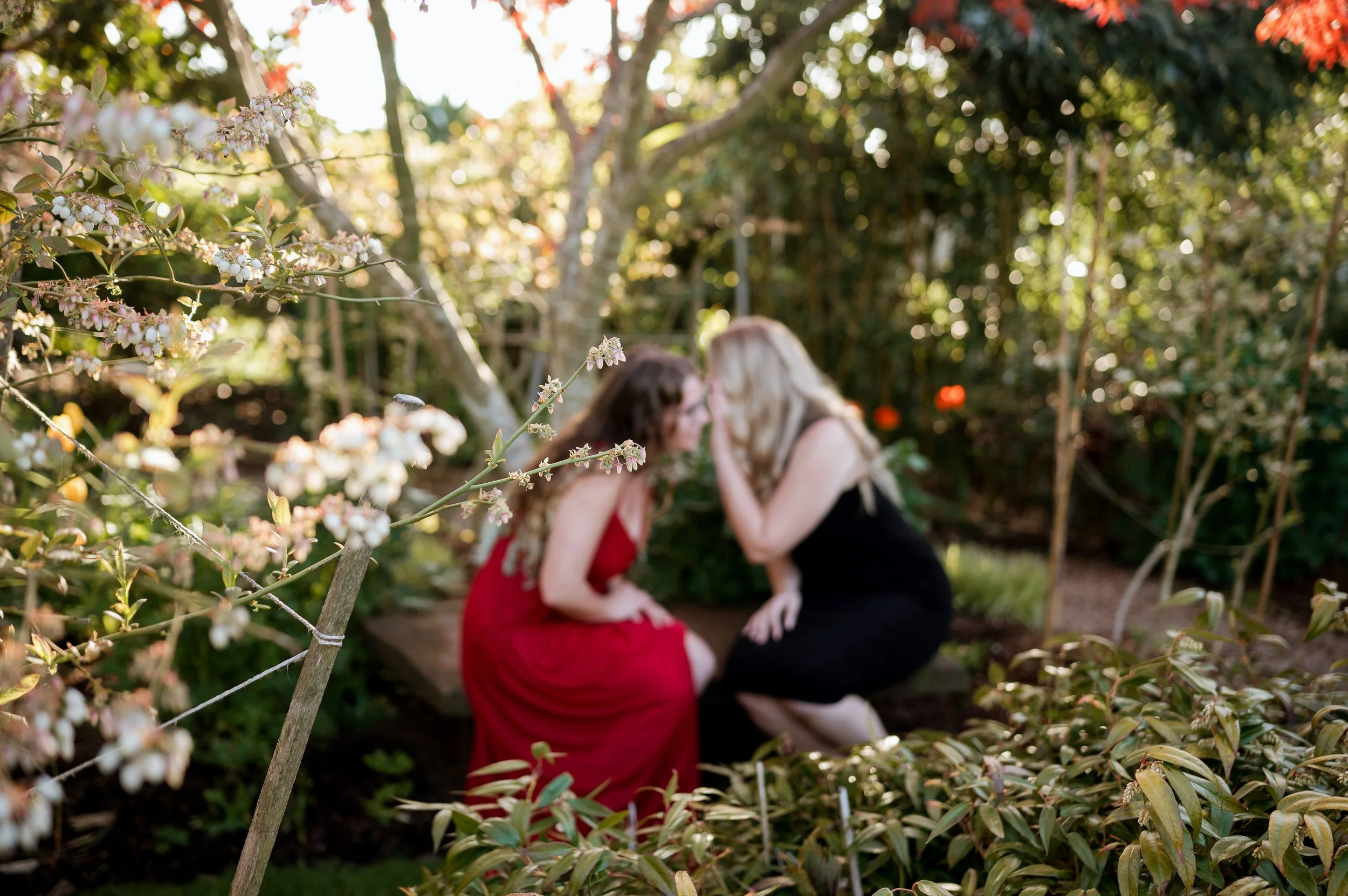 two women whispering together