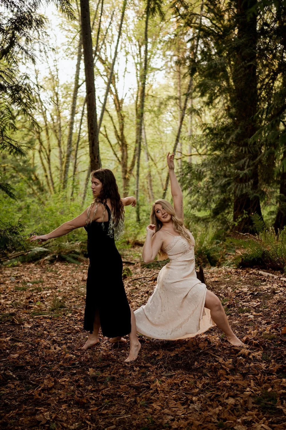 two women therapists dancing in the forest