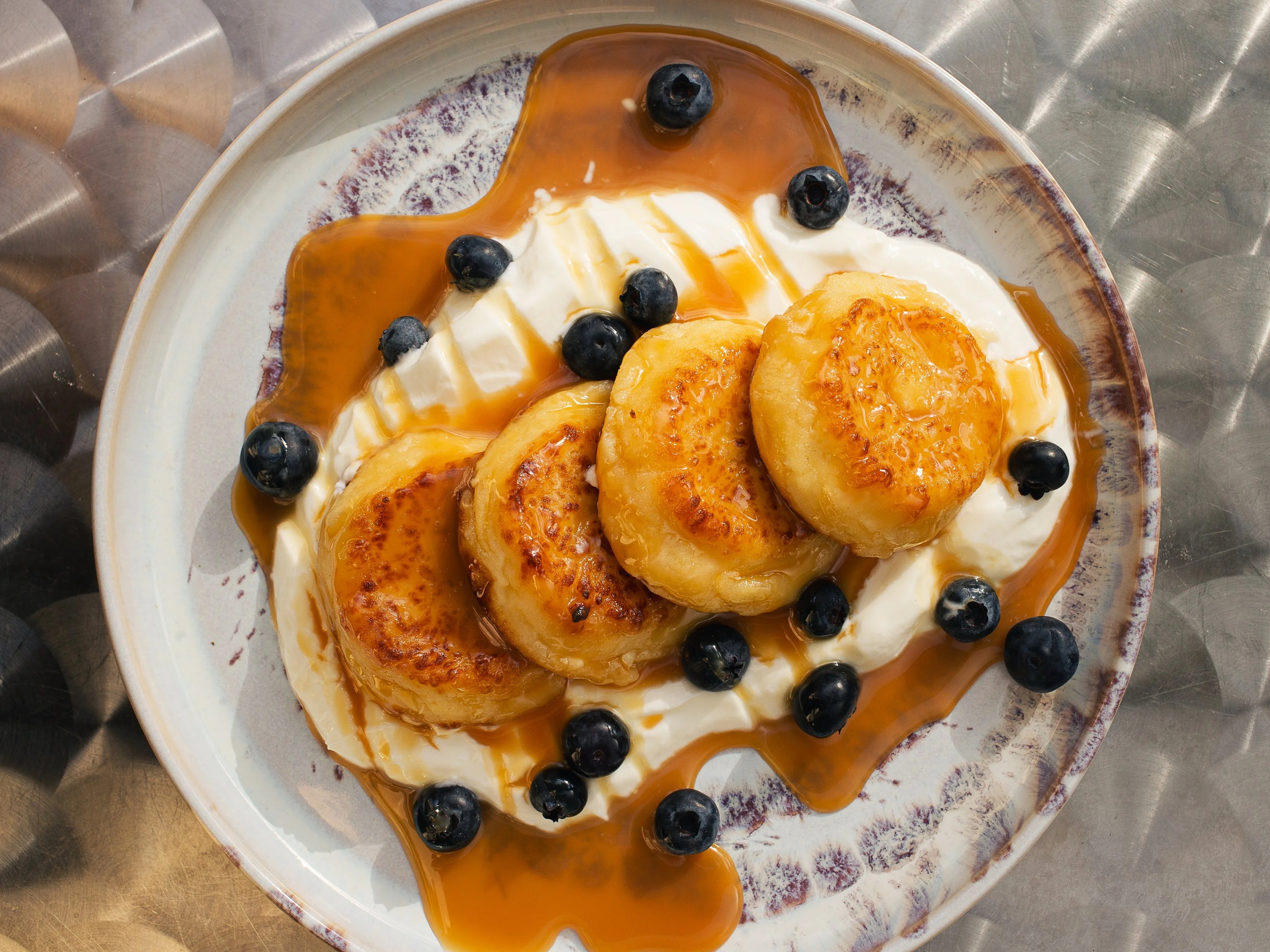 Caramelized with whipped cream and berries, a signature sweet brunch dish in Berlin.