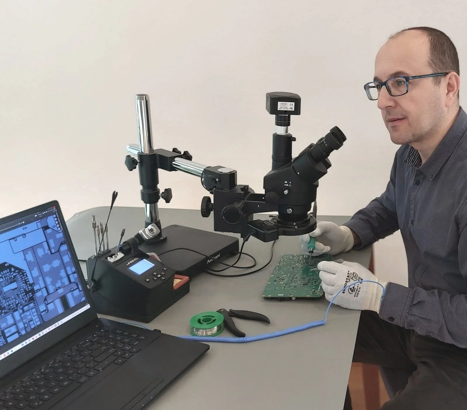 Electronic engineer Marek Gunis soldering on custom board