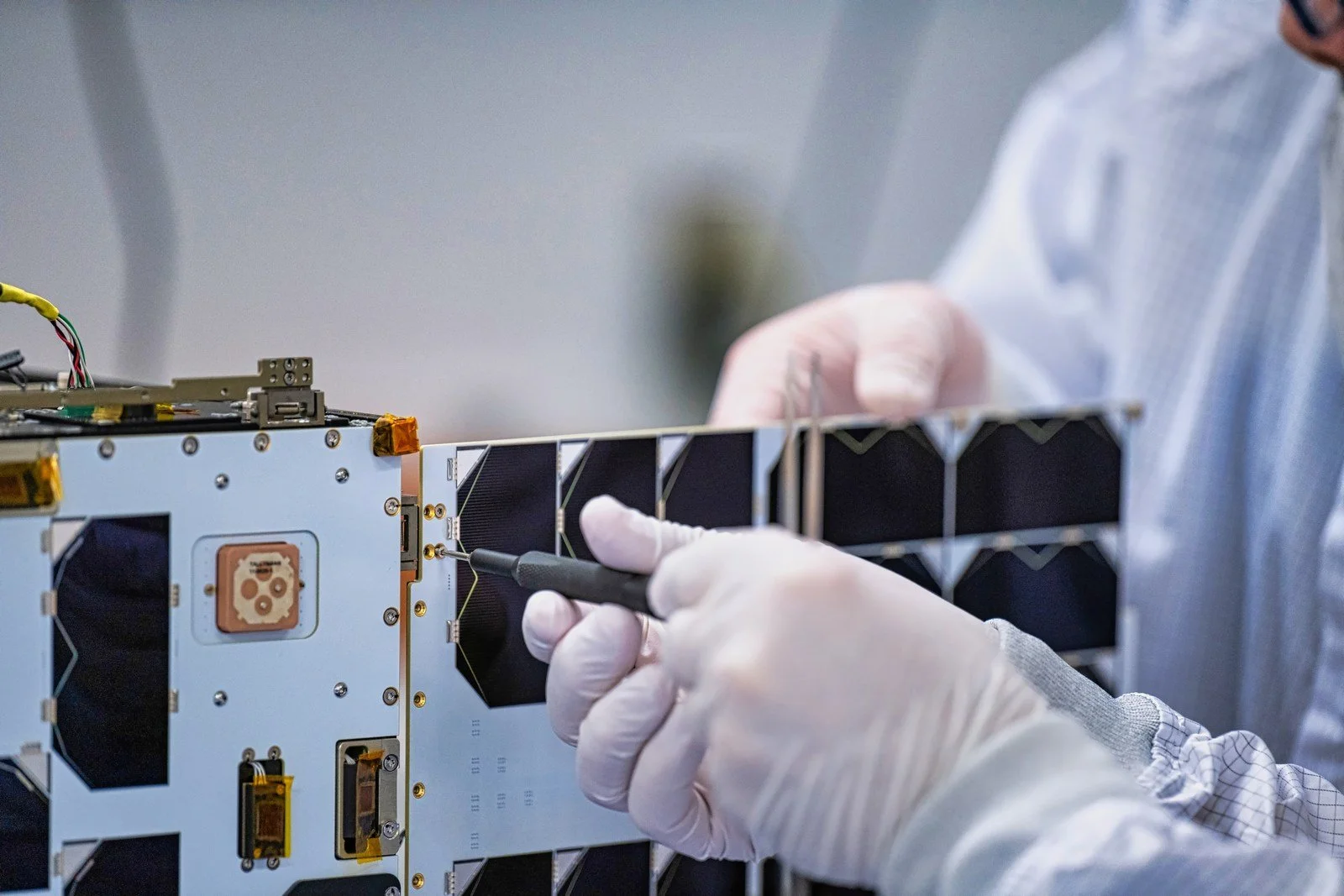 Space technology engineer working on space technology device