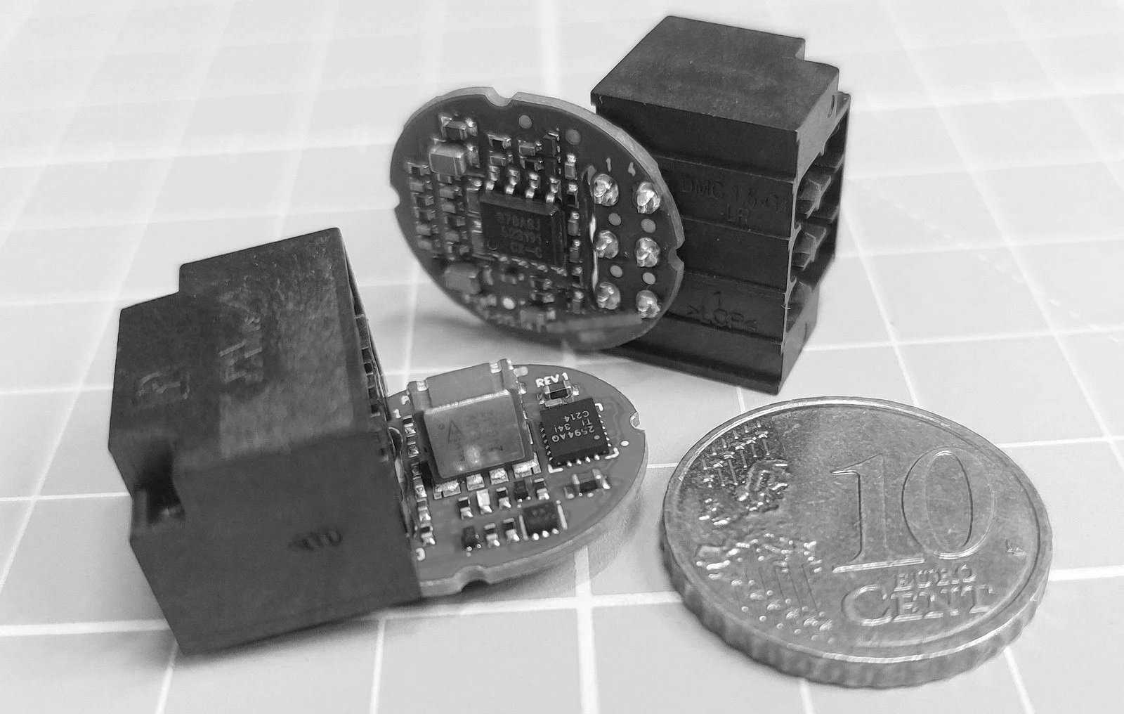 Custom design of ultra-miniature electronic boards with coin to present scale