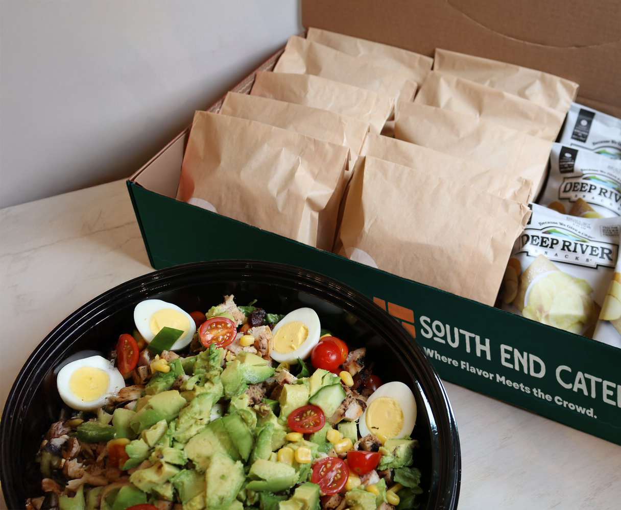 Catering salad platter with bagged meals