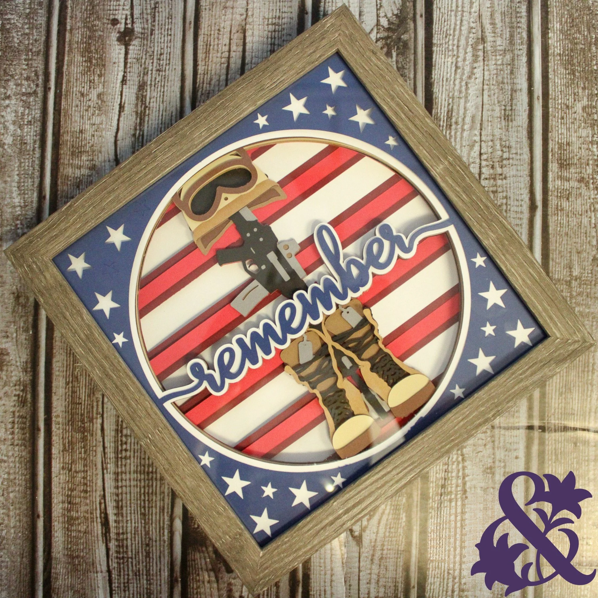 Framed patriotic veteran shadow box featuring a service member, American flag stripes, and stars