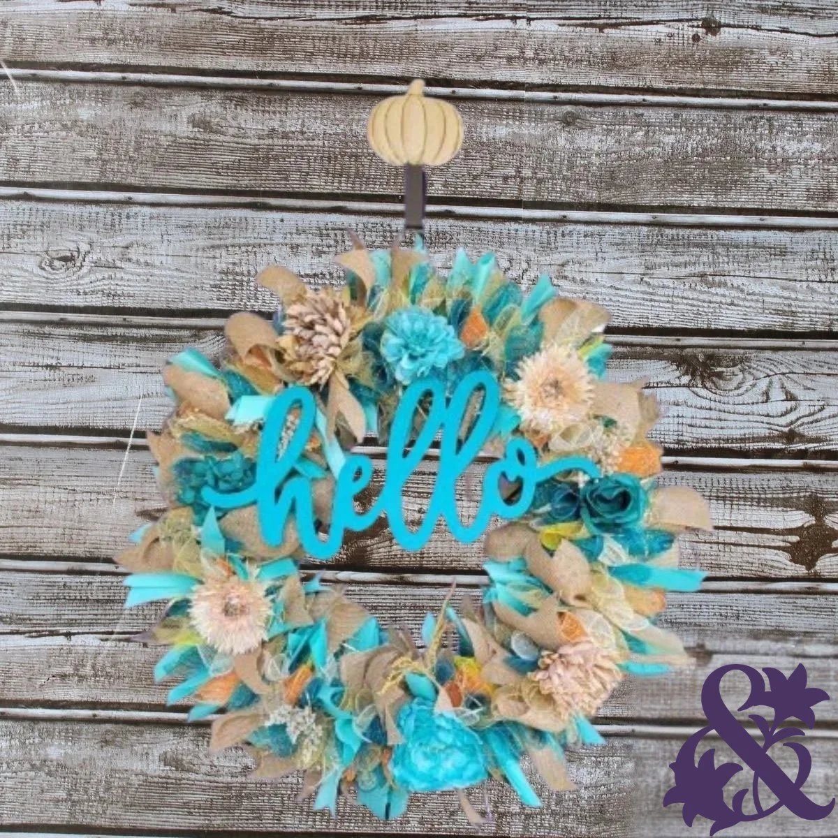 Handmade seasonal wreath with teal and natural burlap, coordinating flowers, a Hello sign, and a small pumpkin hanger