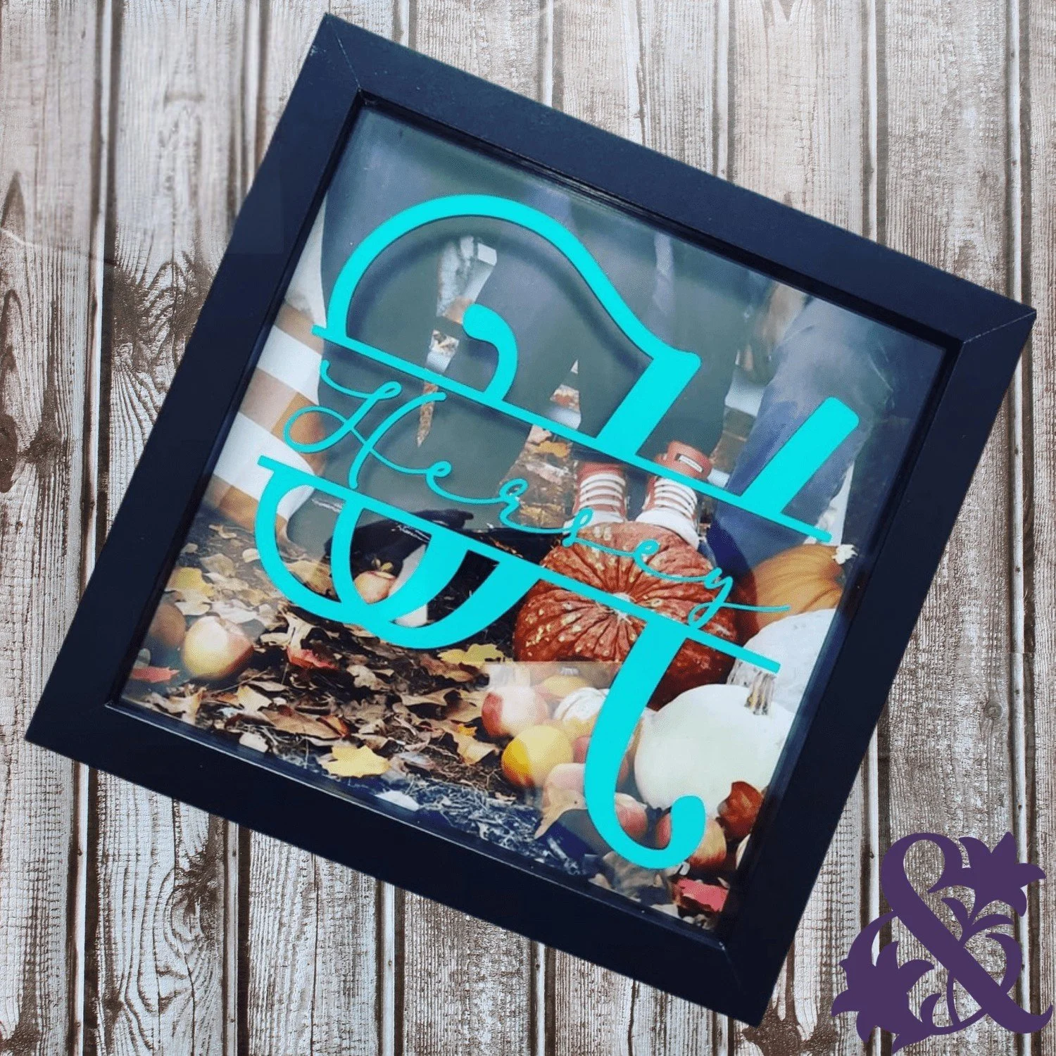 Personalized black photo frame featuring a large turquoise H and the Hersey family name over a family photograph