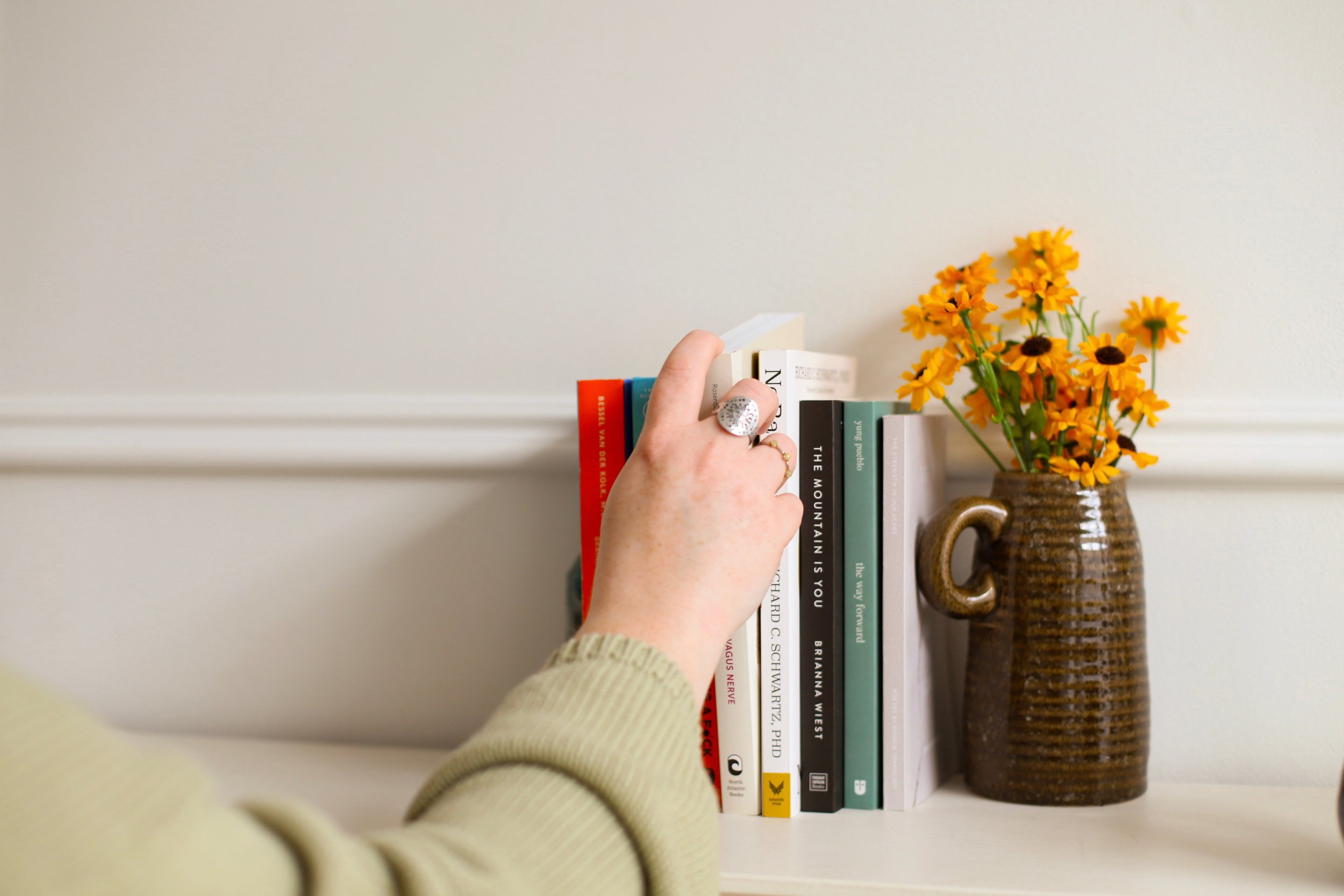 Reaching for books on shelf