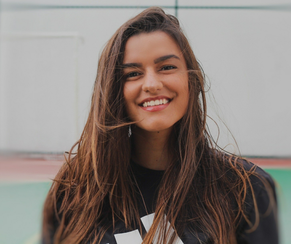 Smiling woman outdoors representing reduced stress and confidence for overcoming dental anxiety.