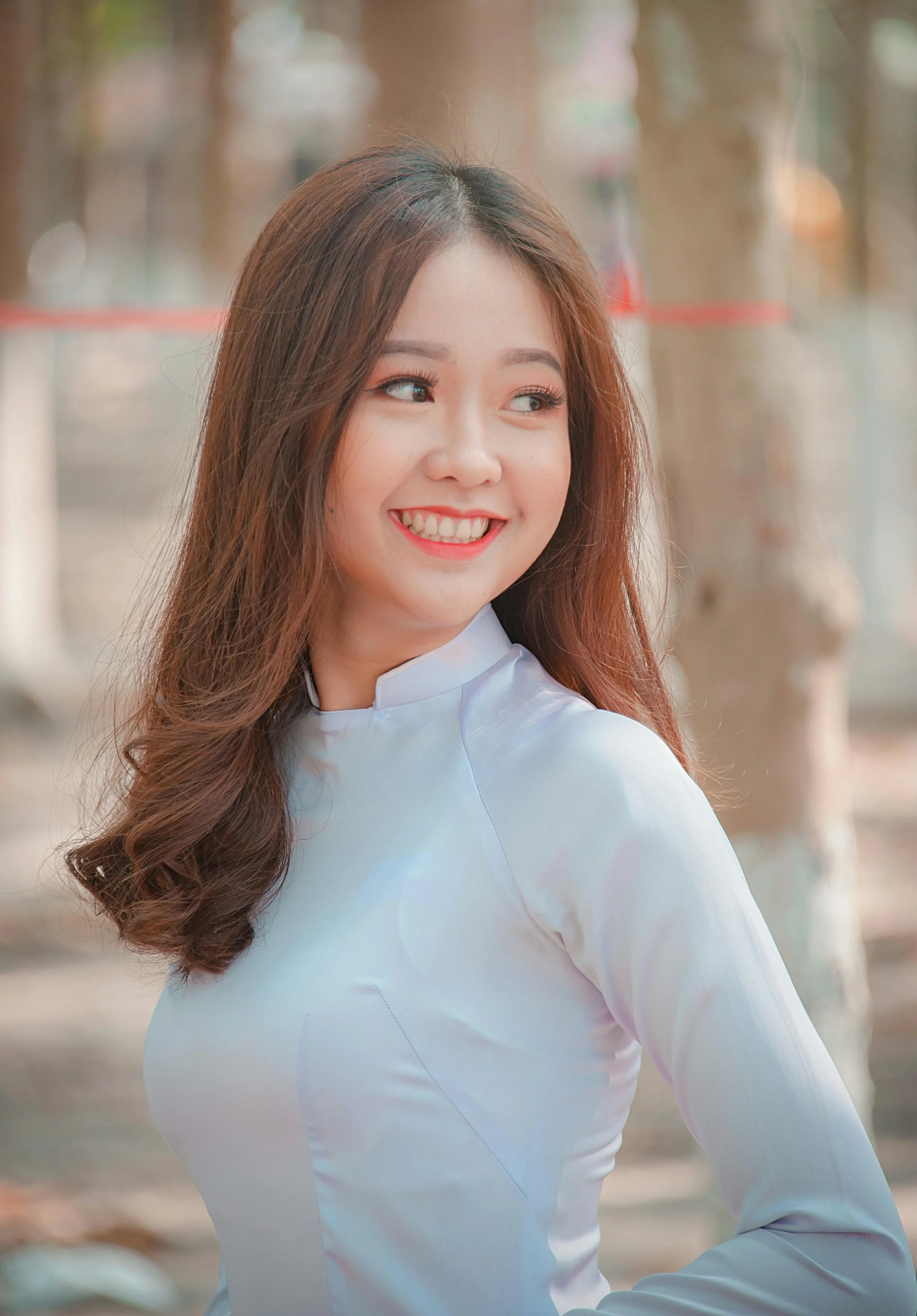 Woman smiling confidently to illustrate how cosmetic dentistry enhances appearance and improves quality of life.
