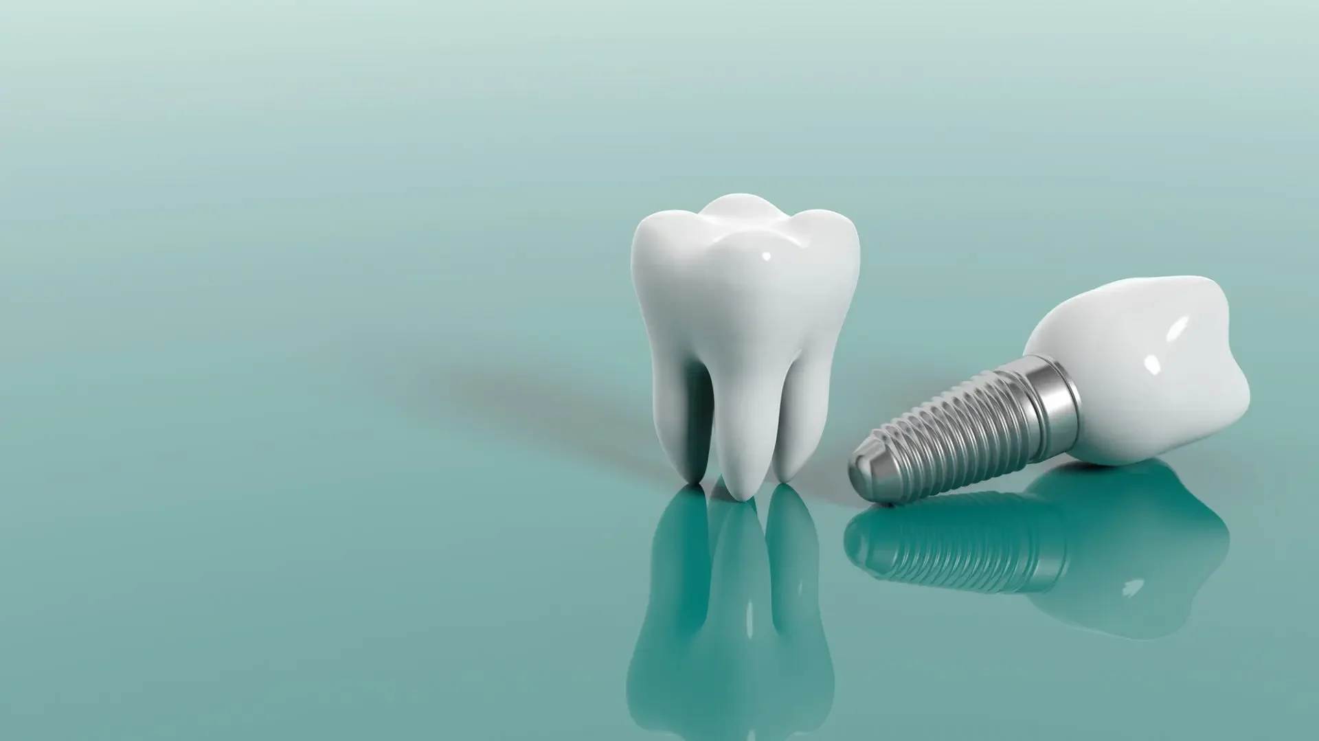 Dental implant with titanium screw beside a natural tooth model on reflective surface