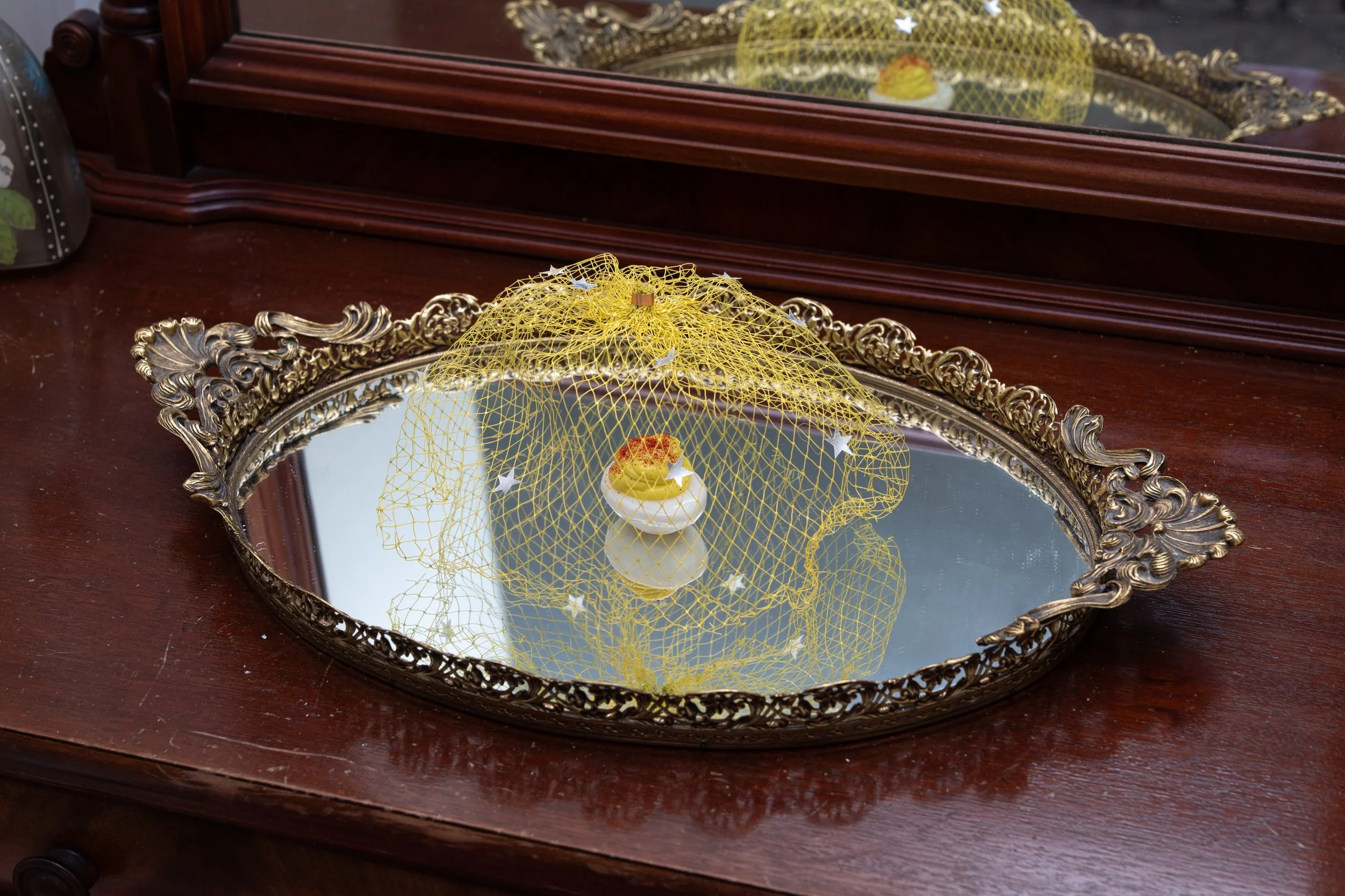 Deviled Egg with Net and Stars, 2023. Photo-etched copper sheeting, enamel, pigmented resin and silicone, sand, embossing powder, Tyvek, sterling silve-leaf, acrylic paint