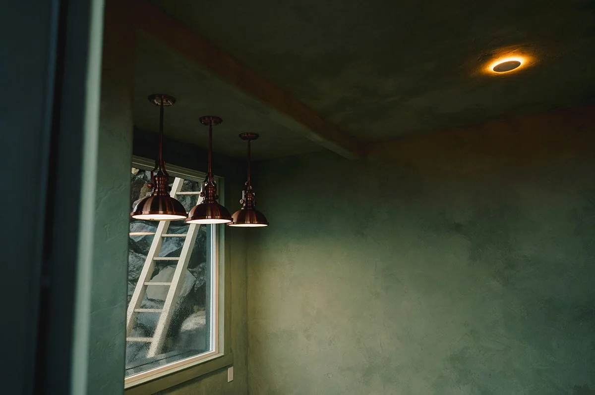 Layered Color Atelier Cypress Ink limewash tones creating soft depth and movement on garden shed walls.