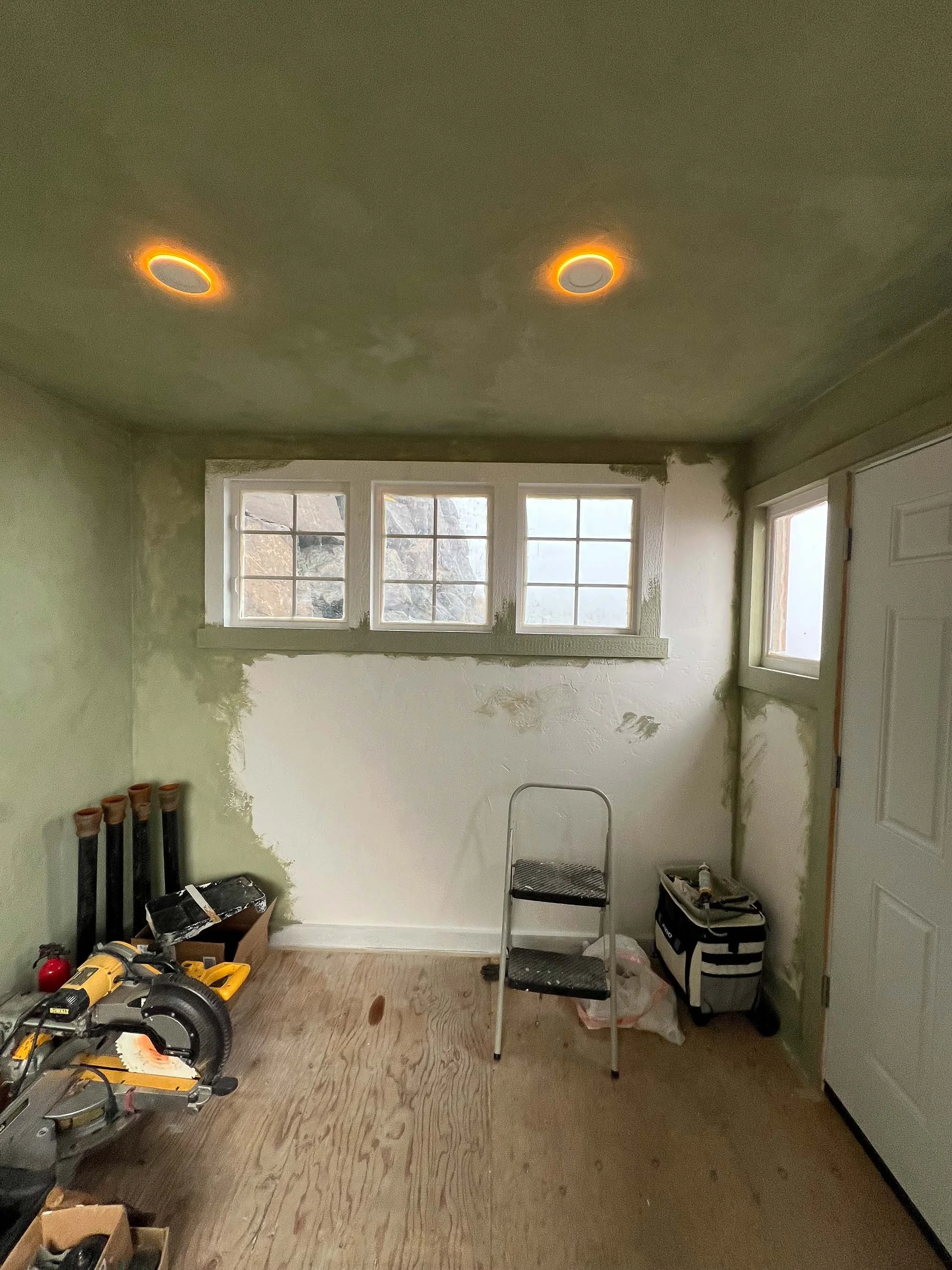 Hand application of Cypress Ink limewash at 200 percent depth inside a garden shed.