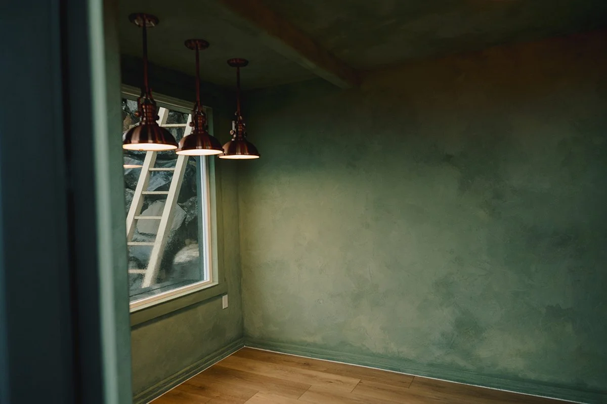 Close detail showing texture and dimensional movement of limewash on garden shed walls.