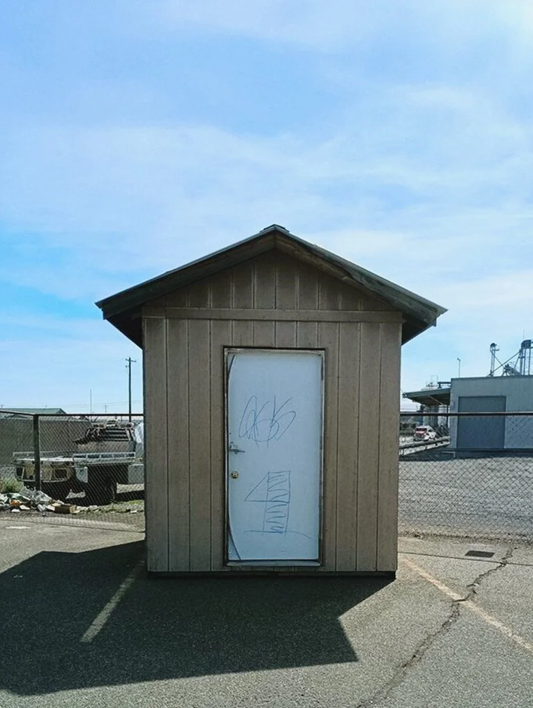 Front exterior of an abandoned garden shed before renovation in Prosser, Washington.