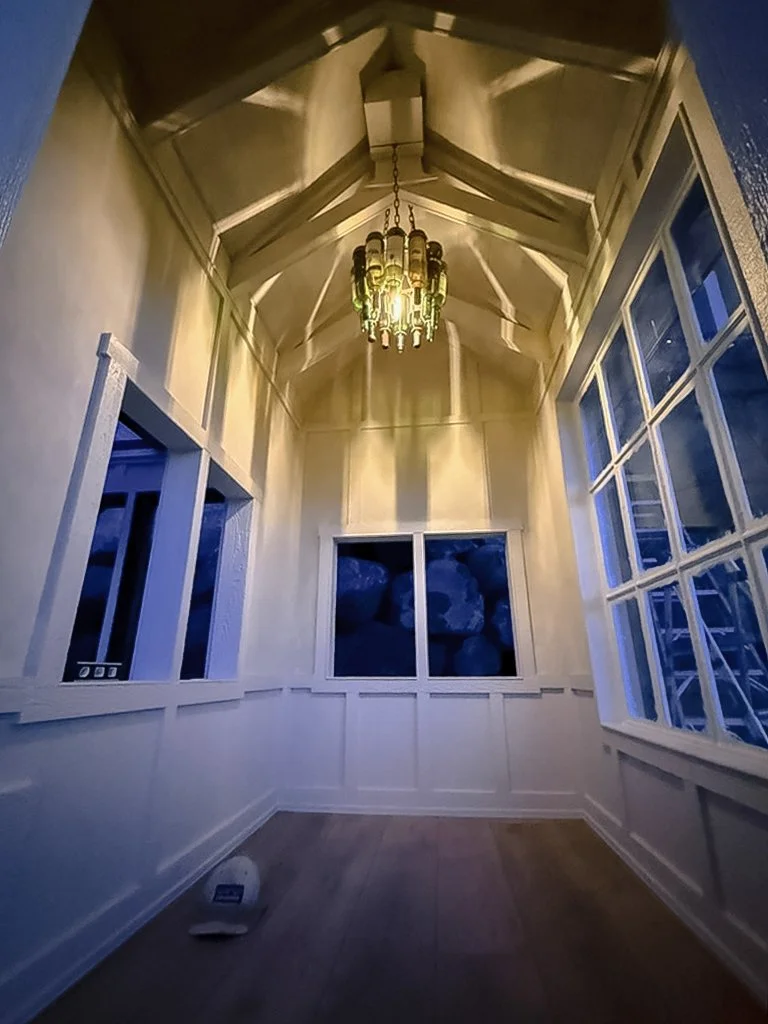 Limewashed chicken coop glowing under night light, showing natural texture and patina by Limewashed by Ob