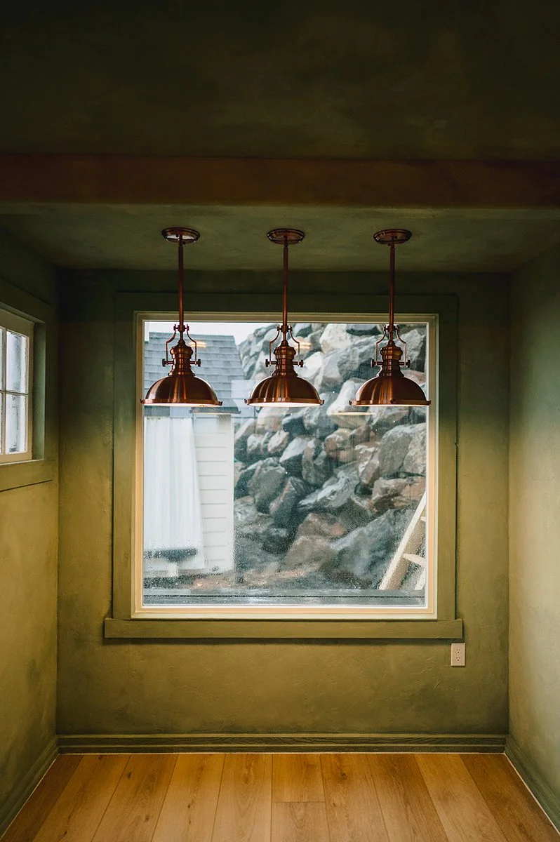 Layered Color Atelier Cypress Ink limewash creating an organic green finish in a garden shed.