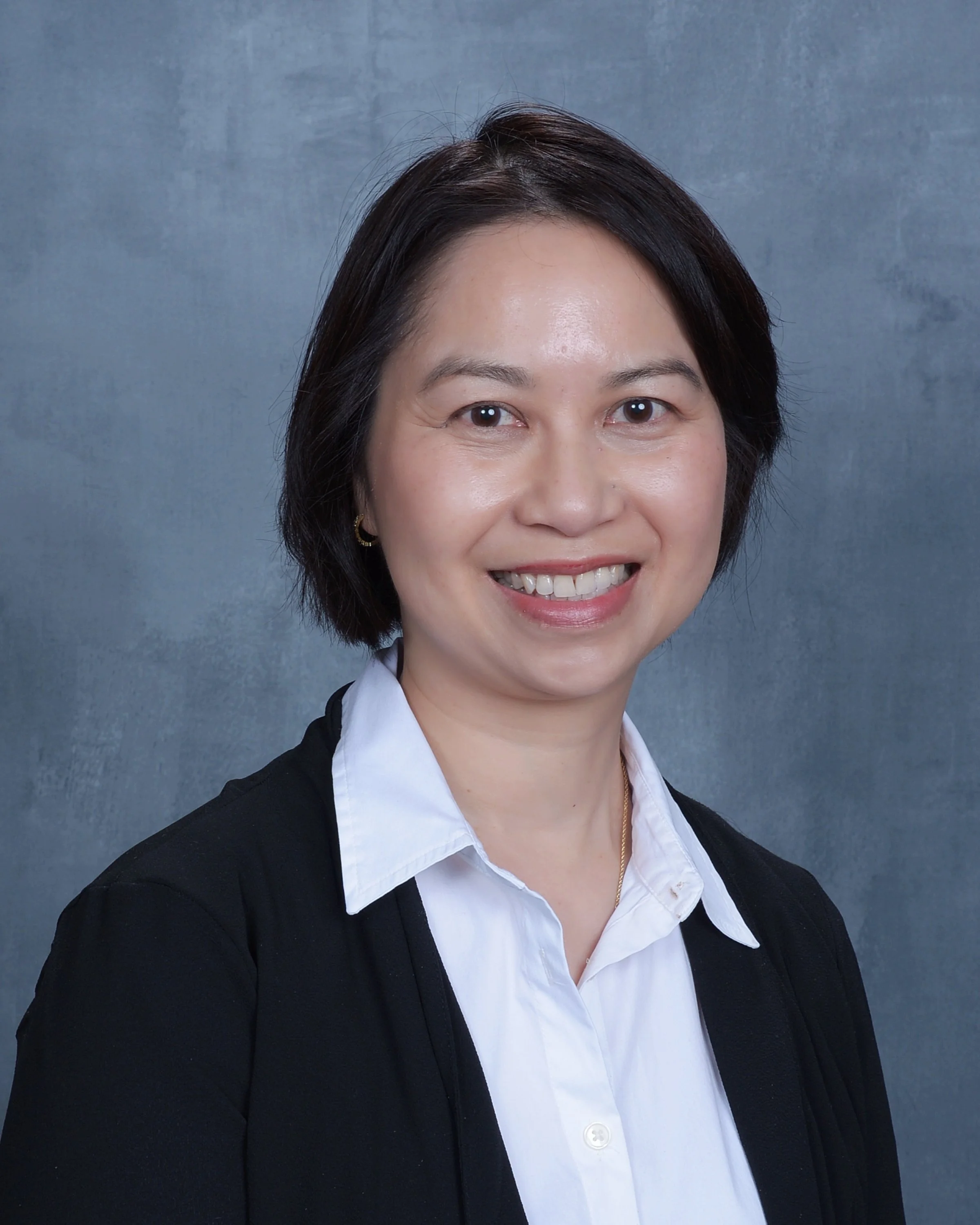 Blurred abstract background with light gradients, primarily in shades of gray and white.