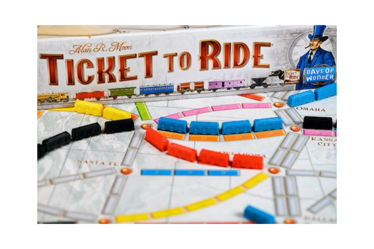 Ticket to Ride board game close-up showing coloured train car pieces on railway routes across US cities