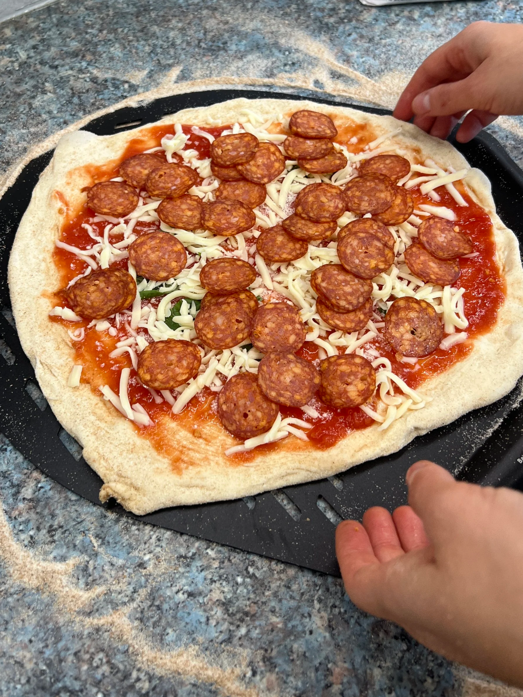 prepping a pepperoni pizza