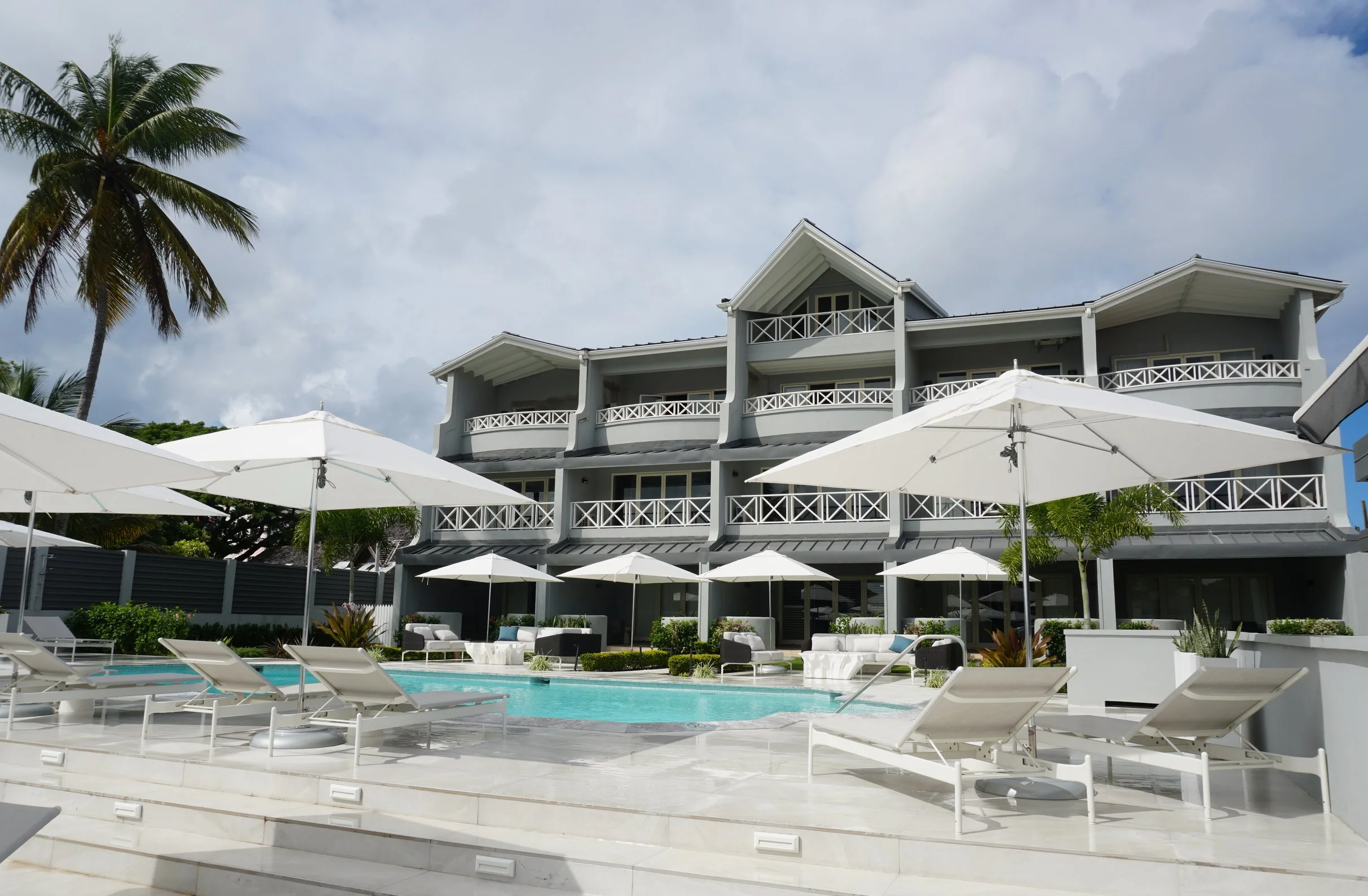 View of Baia Mare Villas with the pool and loungers.