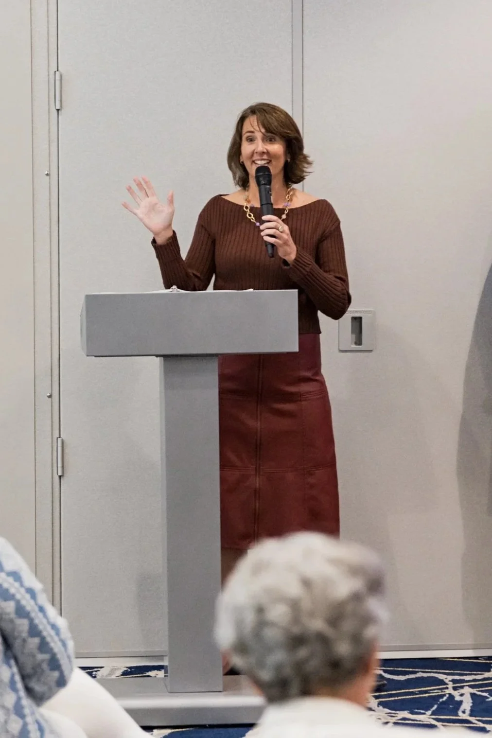 Katherine holding a microphone speaking