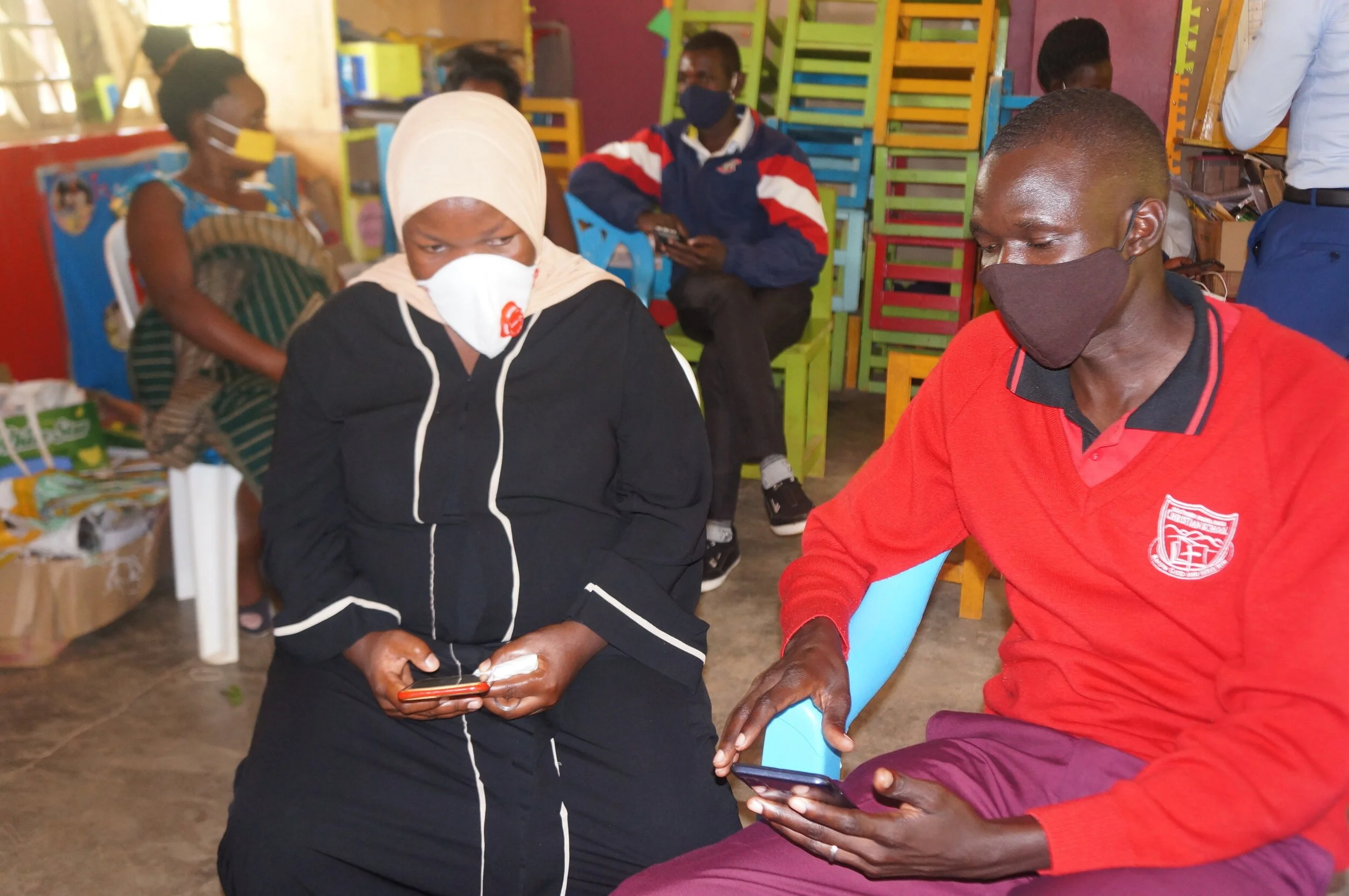 Parents learning how to use Google Classroom on their smart device