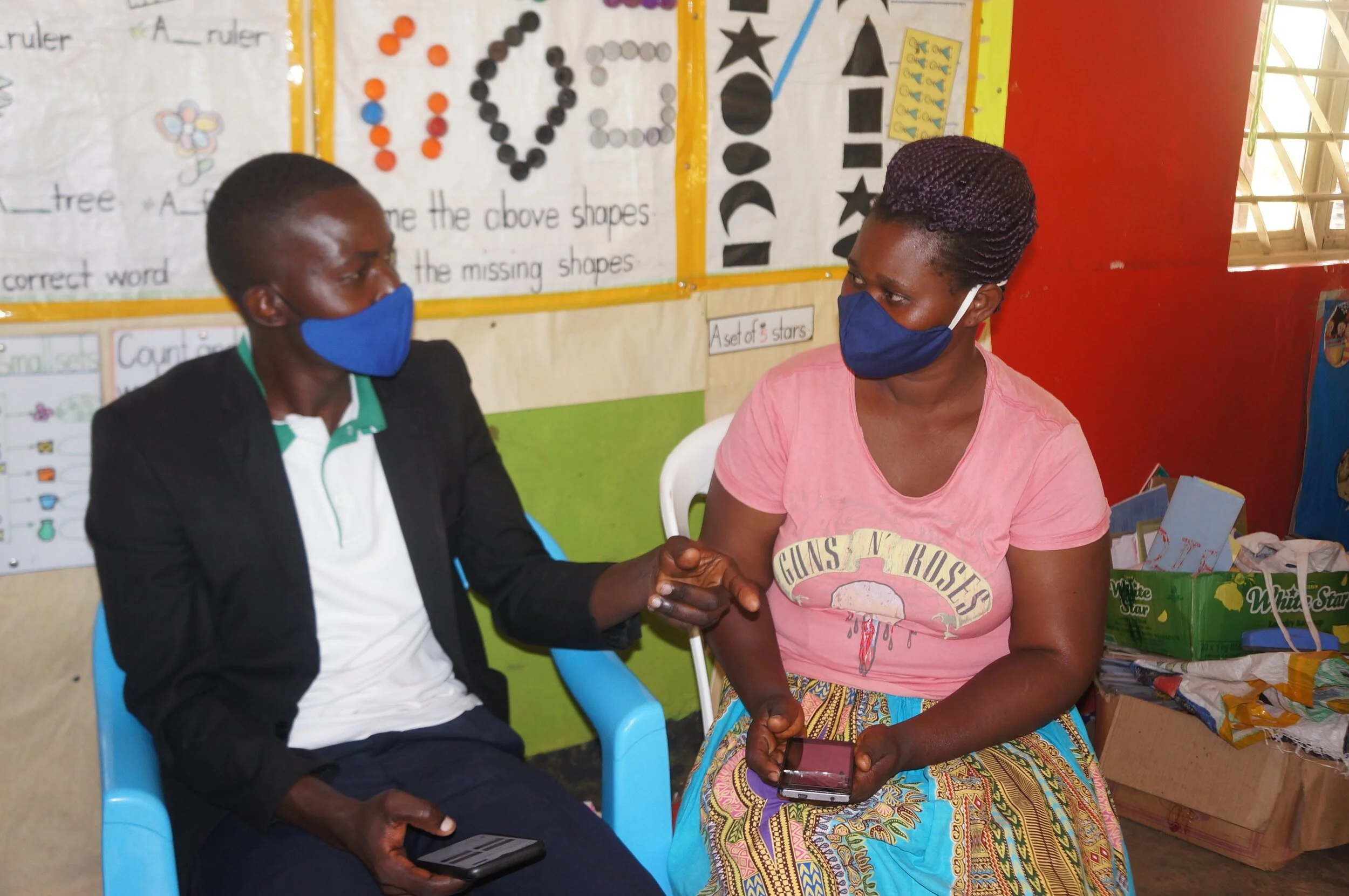 Parents learning how to use Google Classroom on their smart device