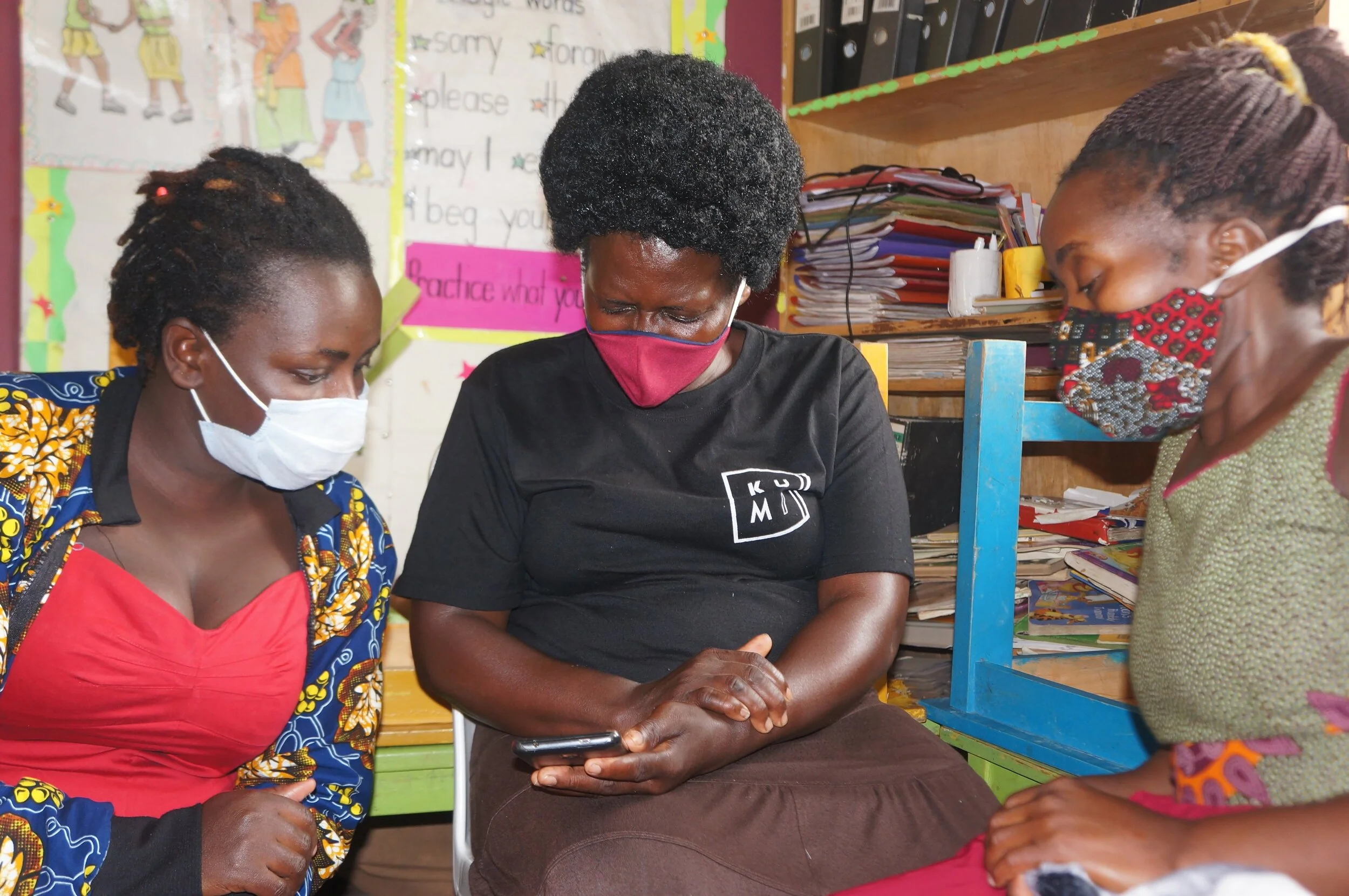 Parents learning how to use Google Classroom on their smart device