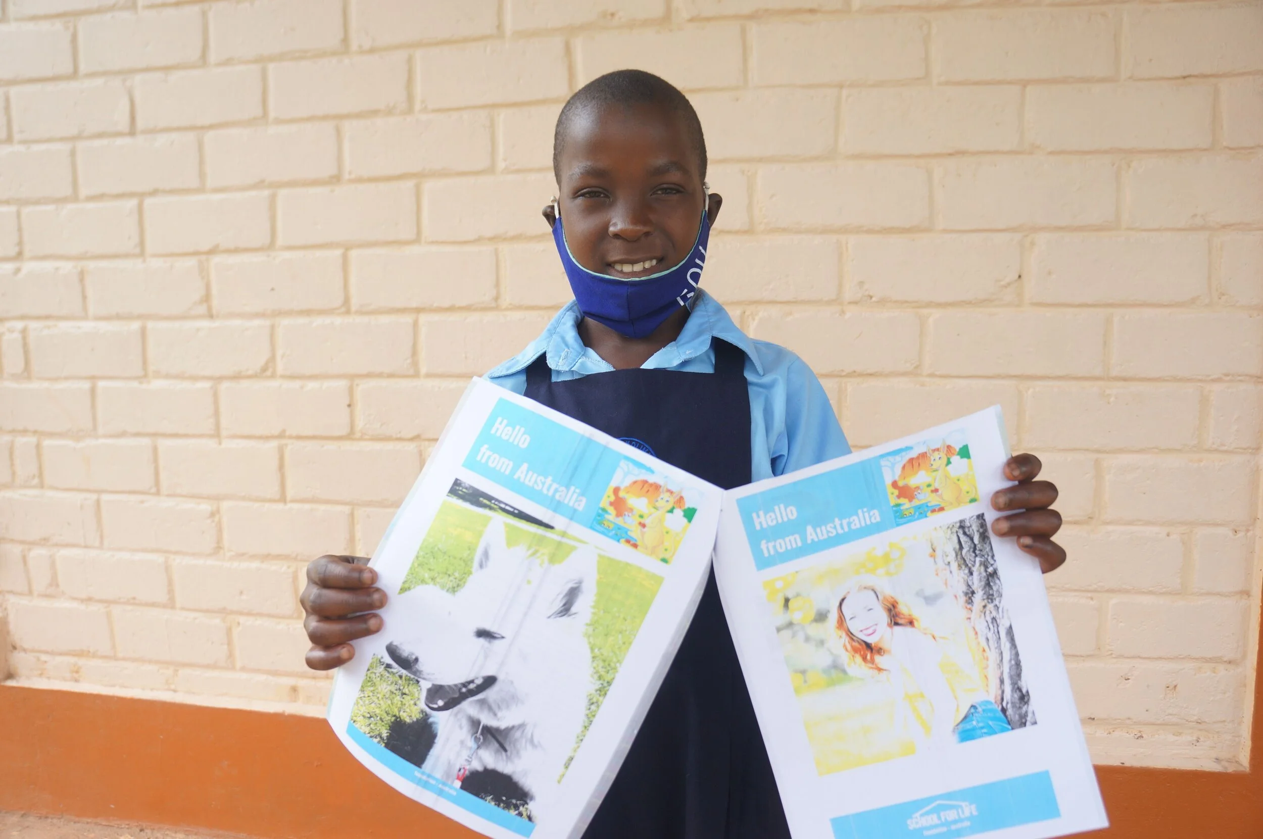 School for Life student Angela with a letter from her sponsor. 