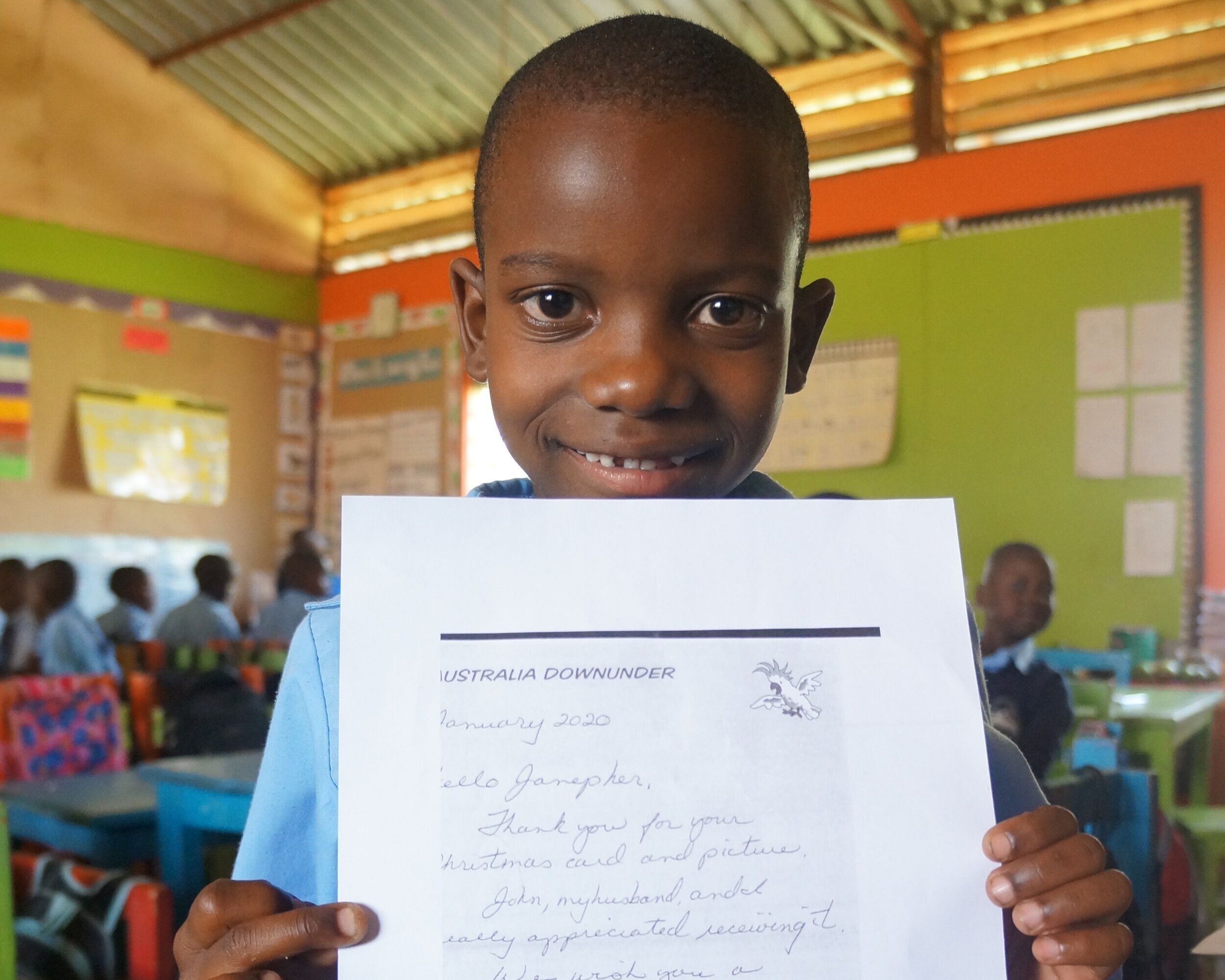 School for Life student Janepher with a letter from her sponsor. 