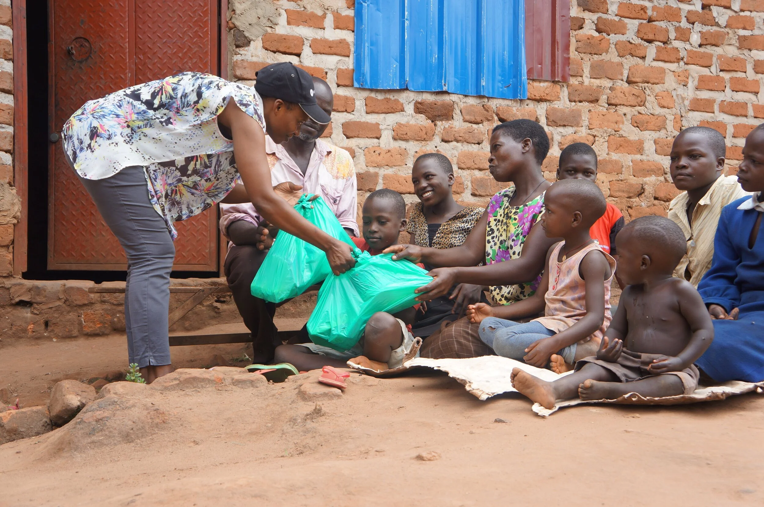 School for Life staff delivering essential food and hygiene packs to one SFL family