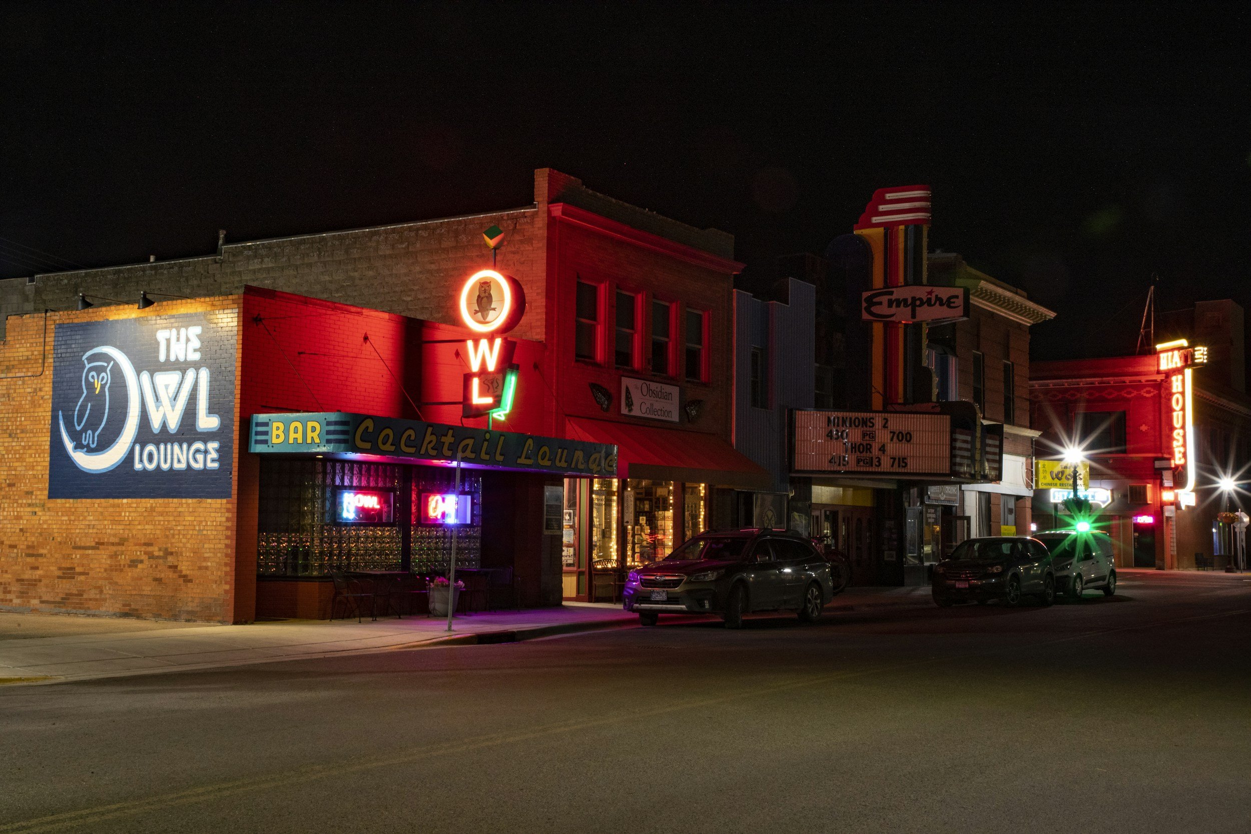 Night scene of Livingston's town streets with cars parked along the road.
