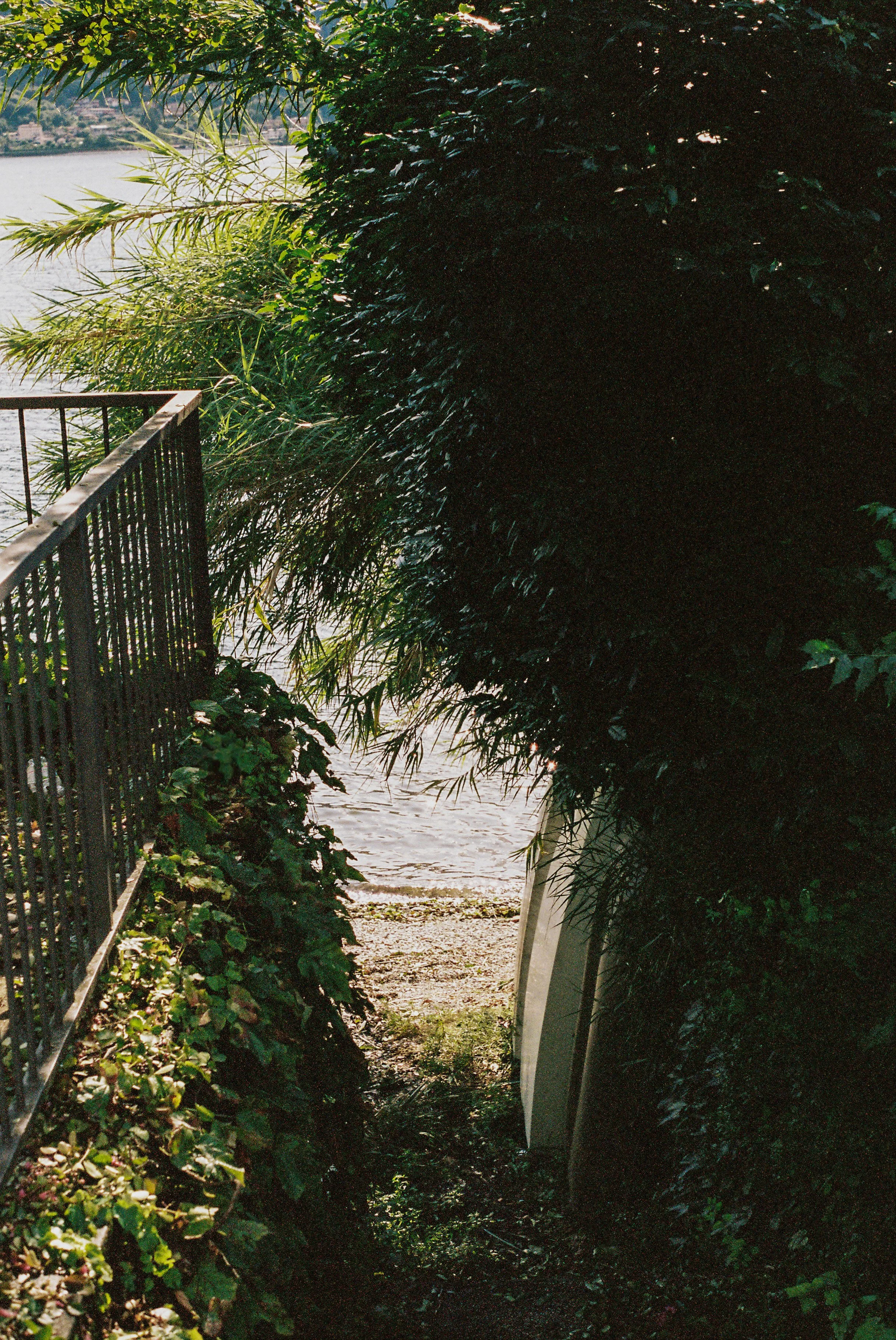 Overgrown lakeside path and boat ramp on Lake Como, Mandello del Lario, Italy — Italy travel photographer and film photographer Anna Hudson
