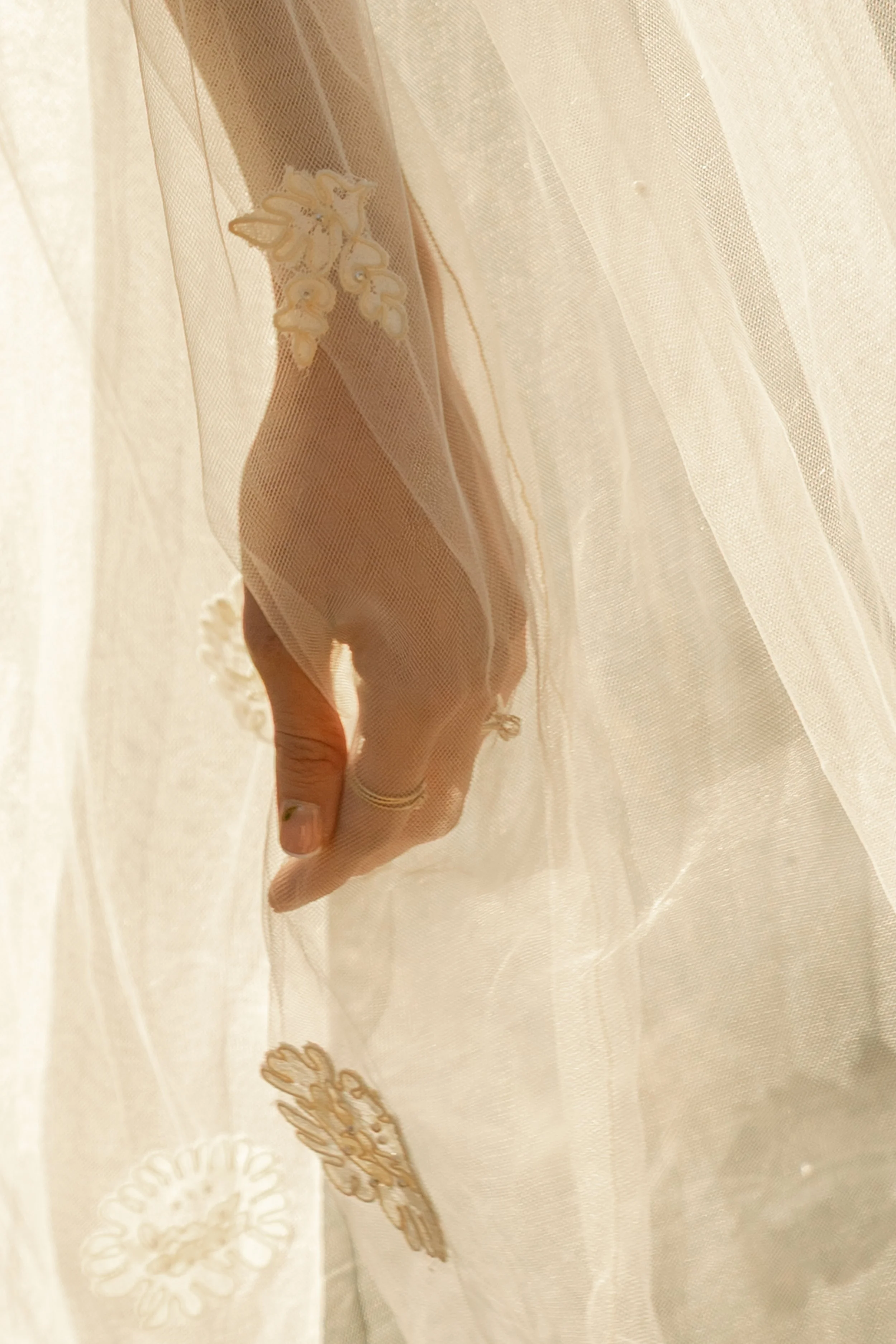 Close-up of a bride's hand with a gold wedding ring draped beneath a vintage embroidered lace veil at a Chautauqua Park elopement, Boulder, Colorado — elopement photographer Anna Hudson