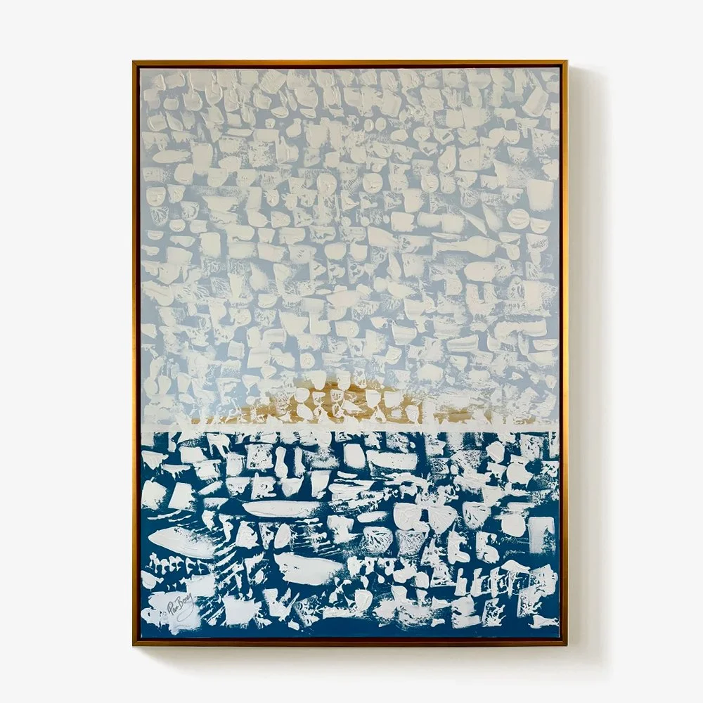 Pam Boney, abstract textured framed painting of various rocks arranged in blocks, with the top half in shades of beige and cream, a middle narrow band of white, and the bottom in dark blue.