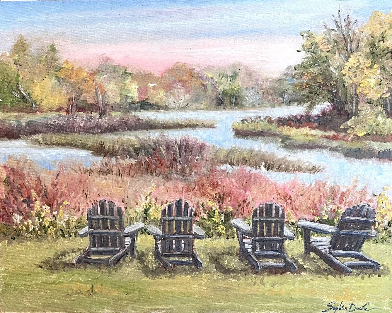 Sophie Dare landscape painting of four wooden Adirondack chairs on a grassy area overlooking Kiawah River, with trees and shrubs in autumn colors under a pastel sky.